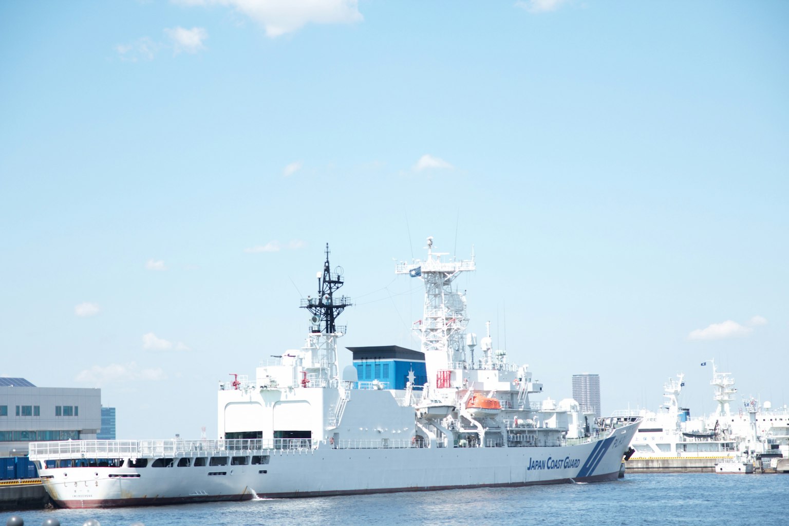 White ship docked at the harbor under a blue sky