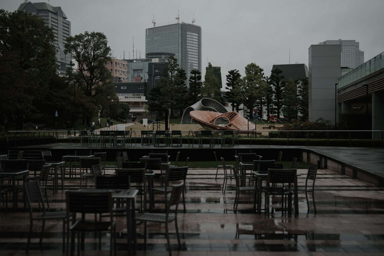 Empty terrace on a rainy day with modern architecture in the background