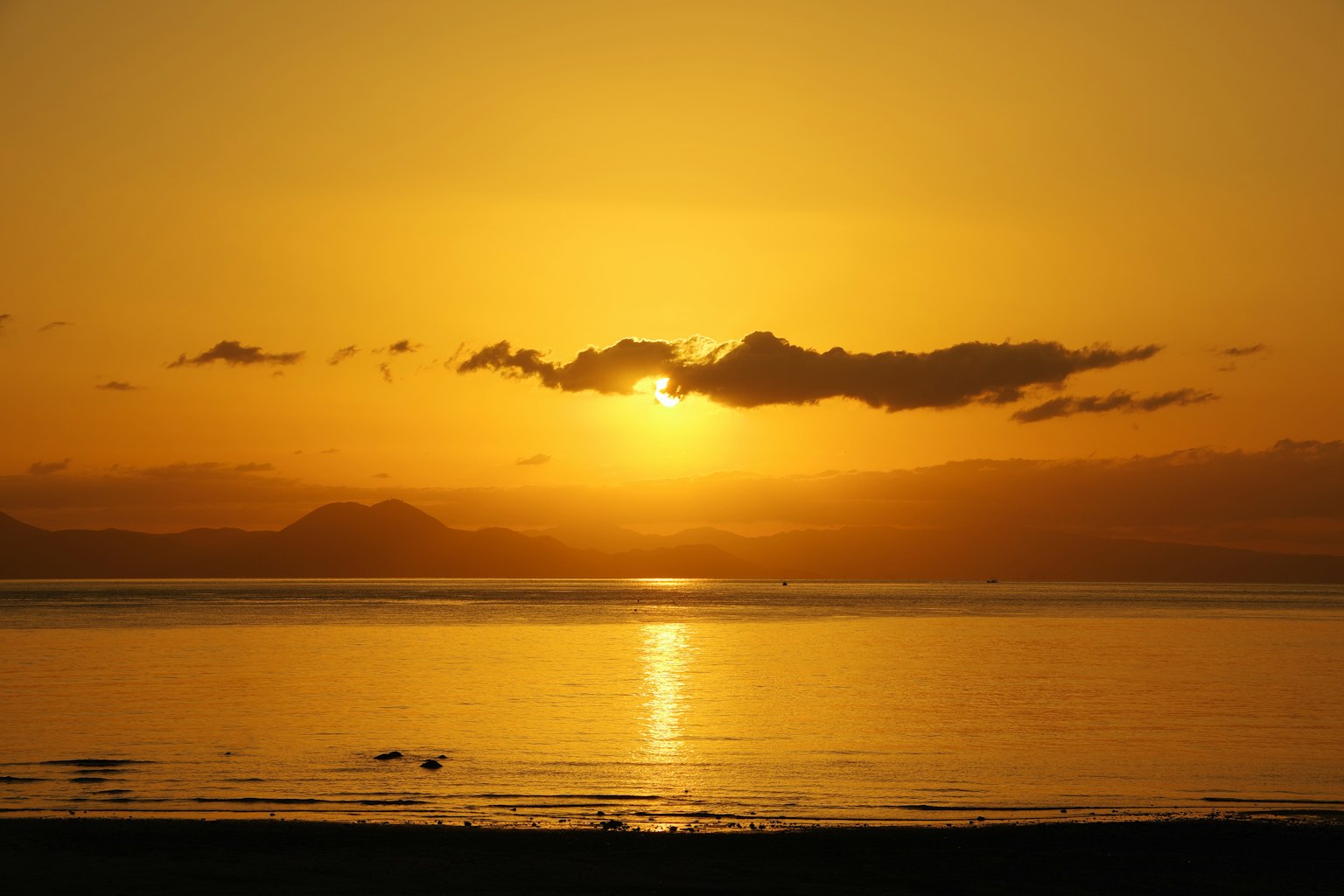 Beautiful sunset over the sea with orange and yellow sky and calm water surface
