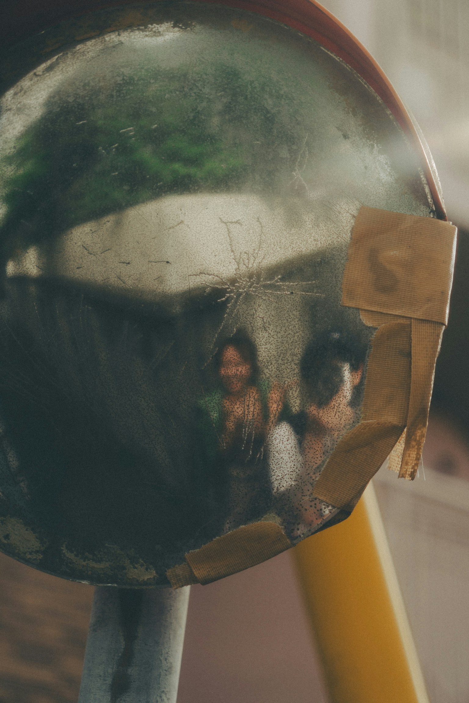 Reflected people in an old mirror