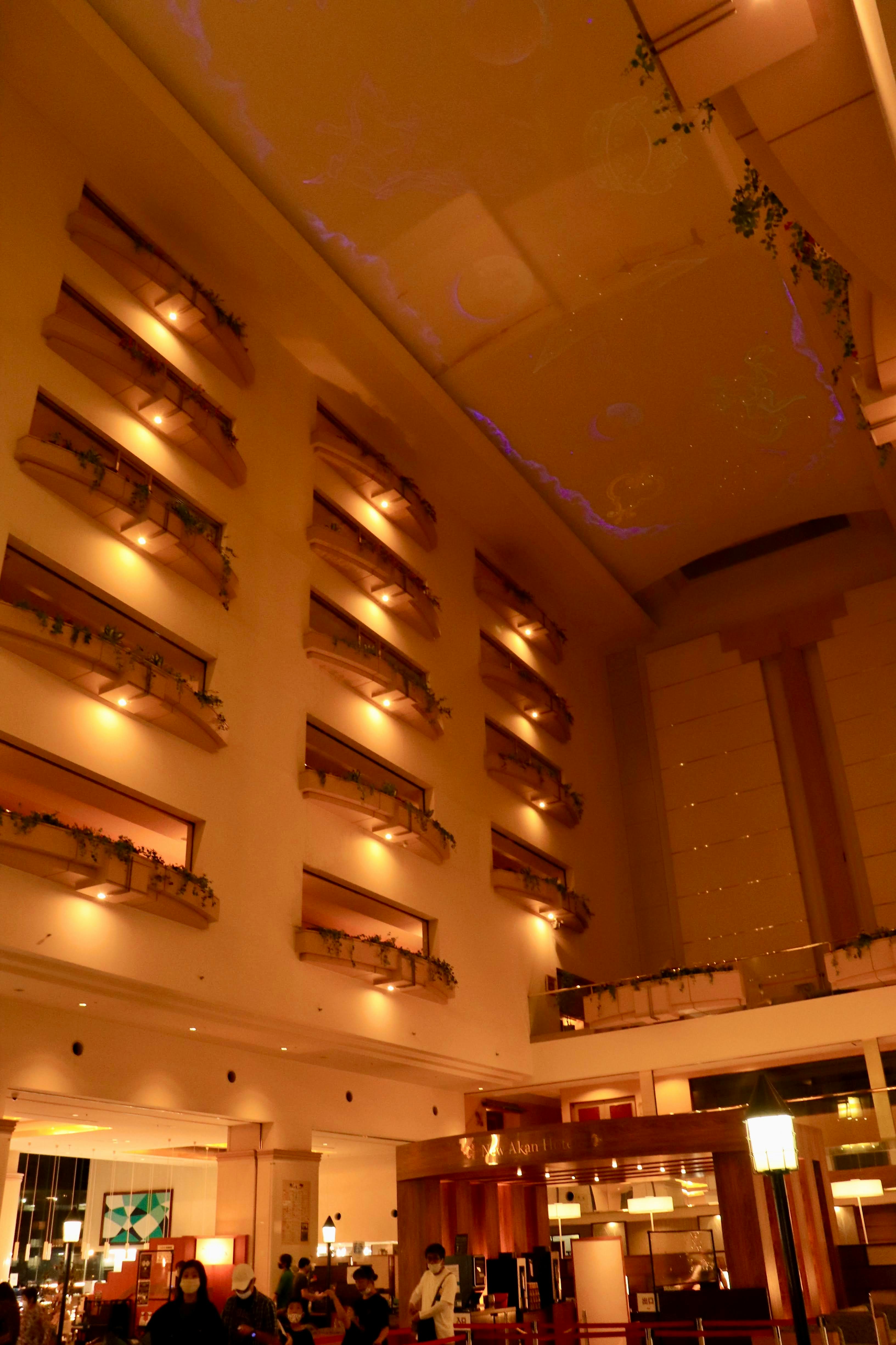 Warmly lit indoor hall interior with people gathered