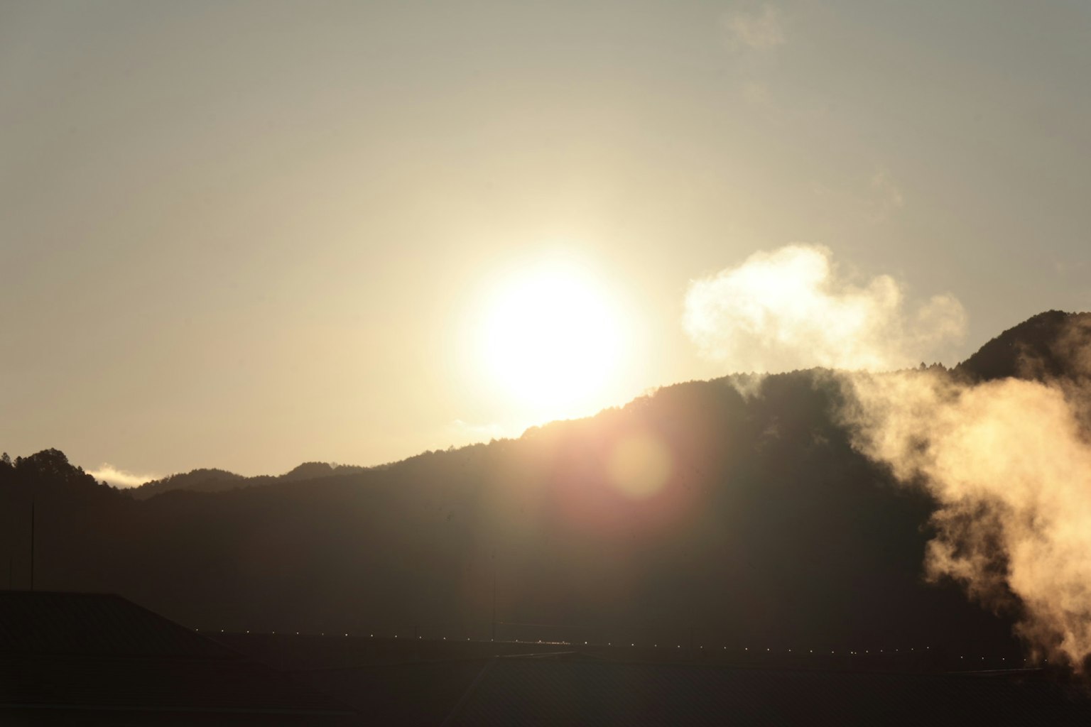 Tramonto sulle montagne con vapore in primo piano