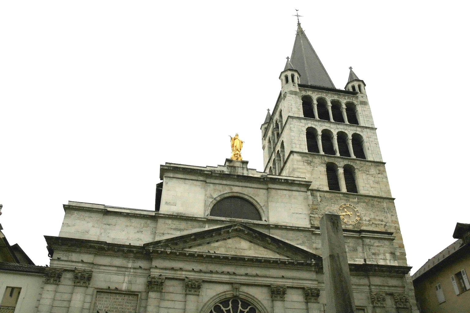 Bâtiment historique avec une tour d'église et une statue dorée