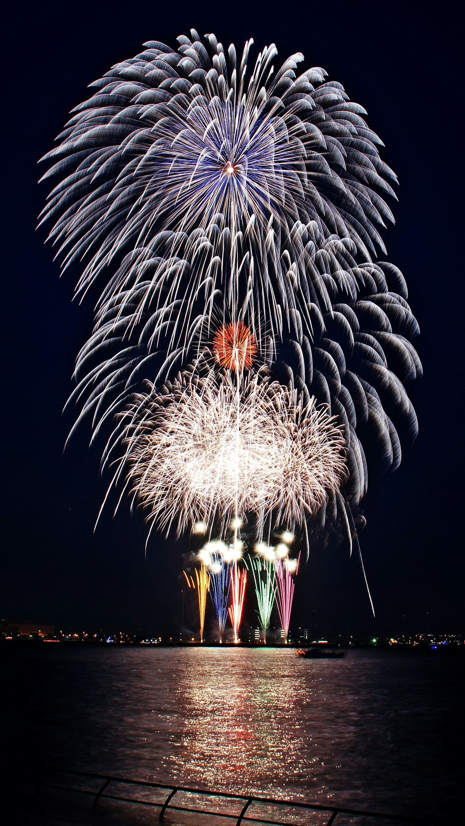 Beautiful display of fireworks in the night sky Large circular fireworks burst with colorful lights illuminating the night