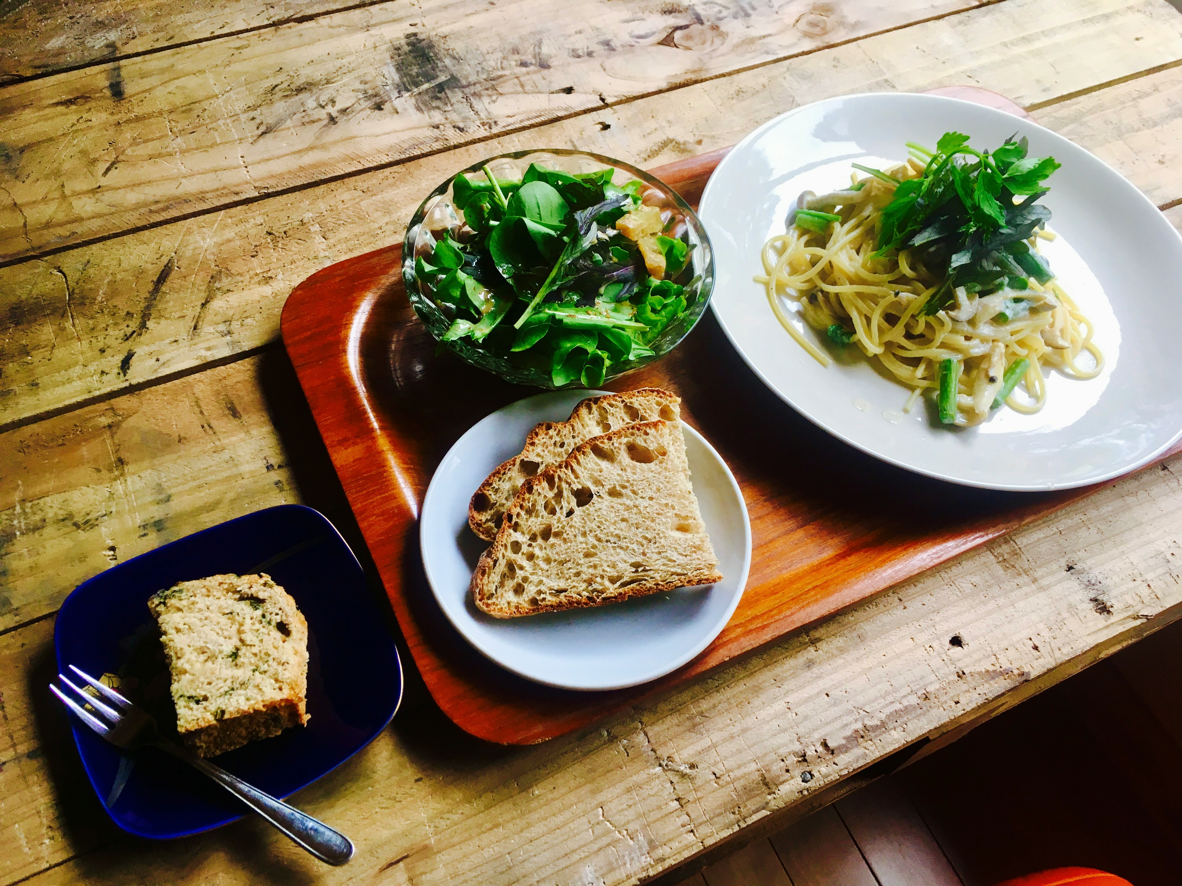 lunch plates with pasta, salad, bread and dessert