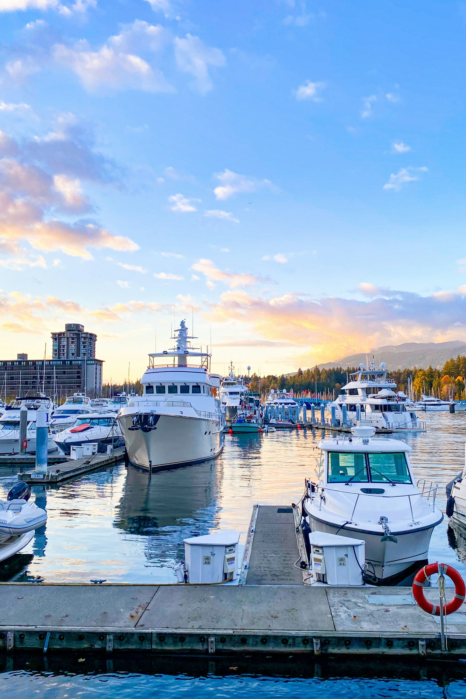 Beautiful sunset at a marina with yachts and boats docked