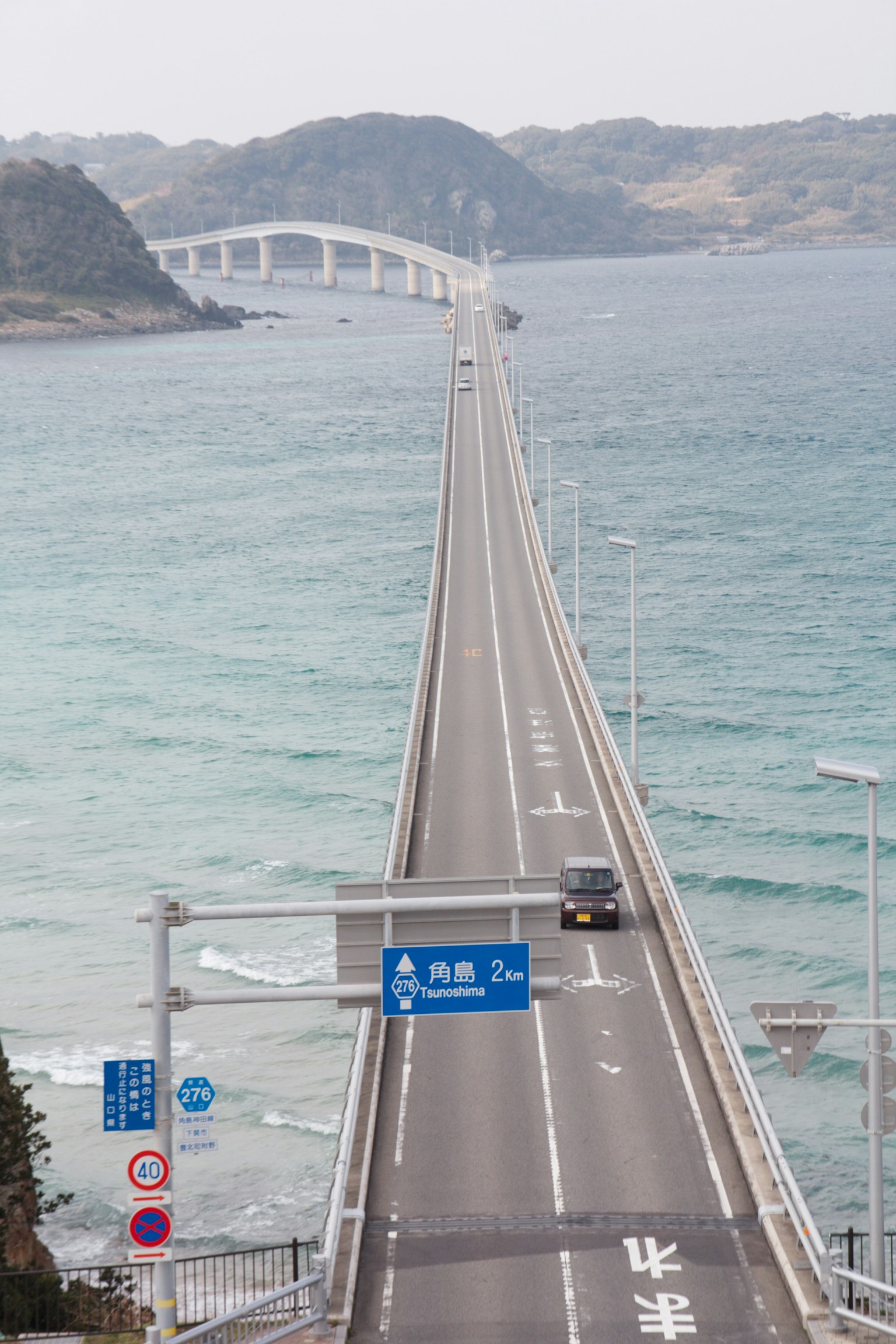 Una larga carretera que lleva a un puente sobre el mar
