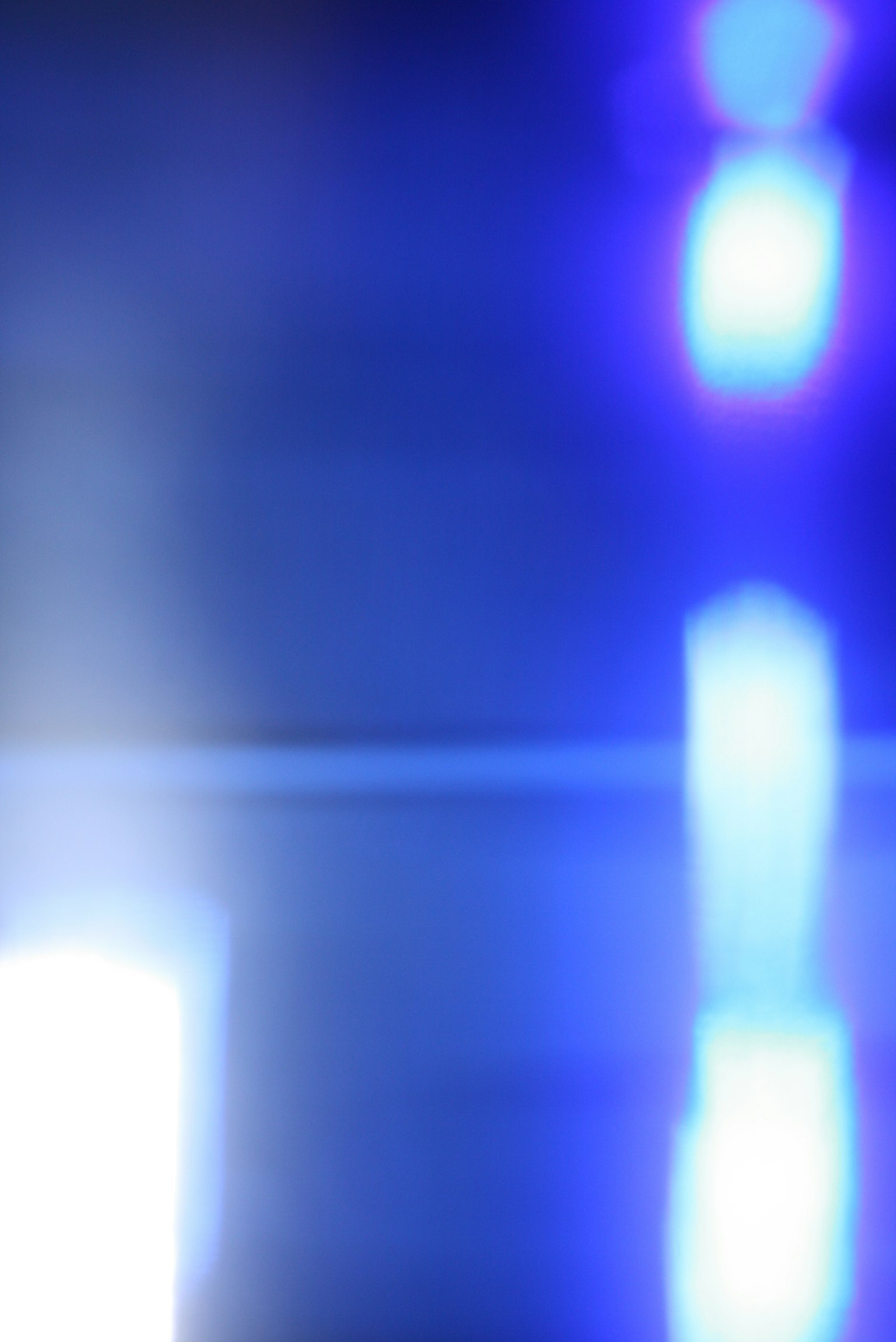 Abstract image featuring blurred blue and white light effects