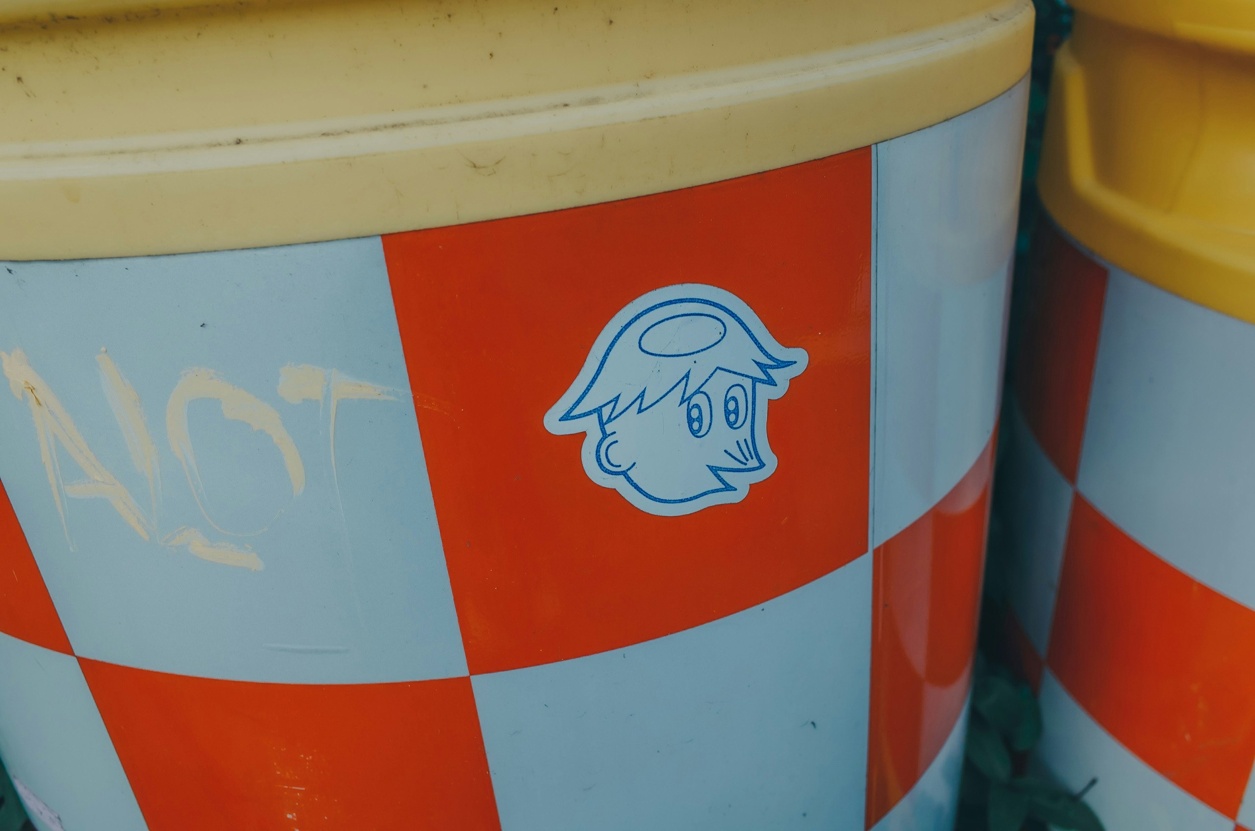 Character illustration on an orange-and-white barrier