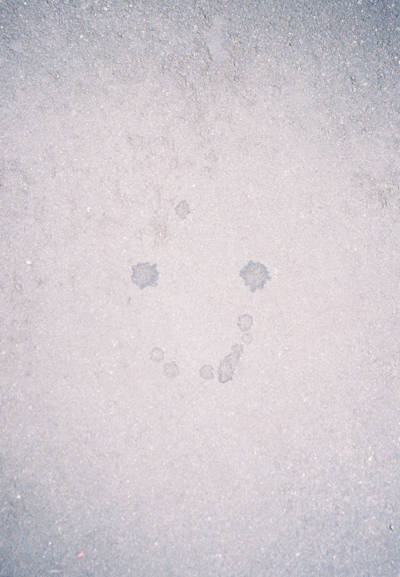 Water droplets forming a smiley face on a white background