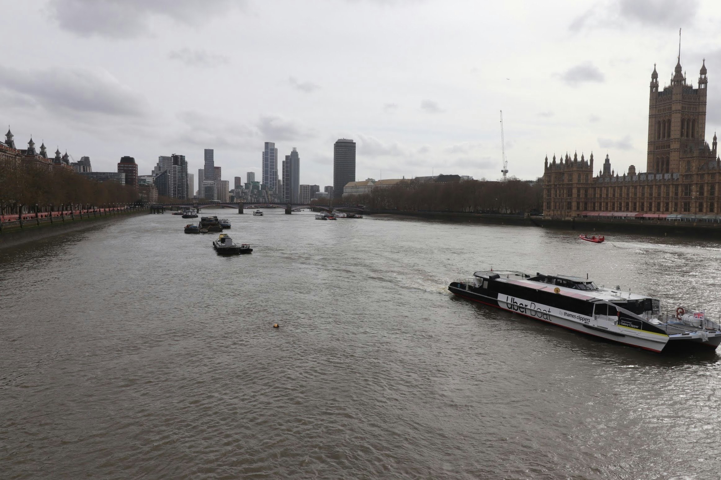 boats on a river with London skyline