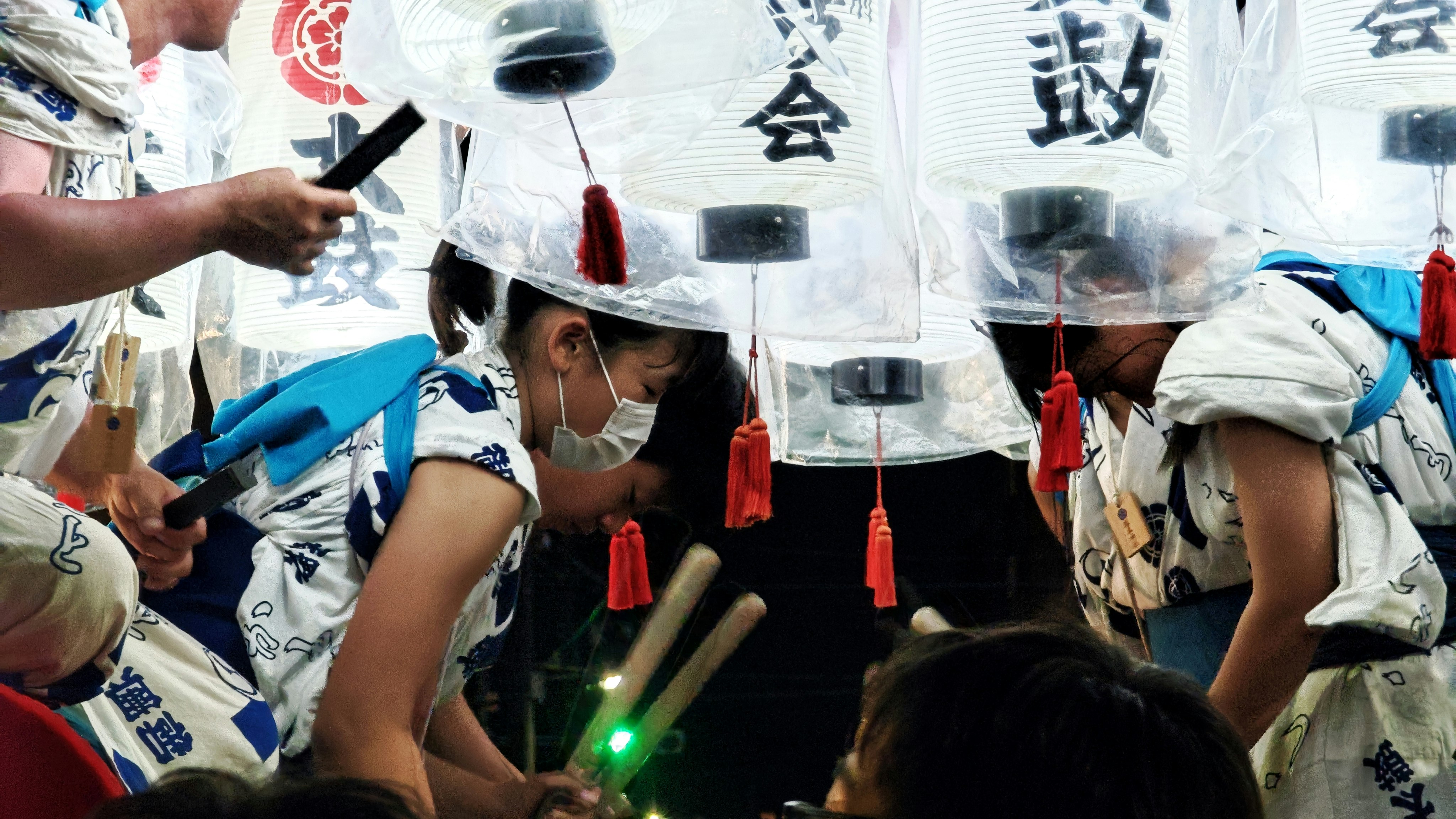 Children in happi coats at Tsukamoto Festival night street stalls