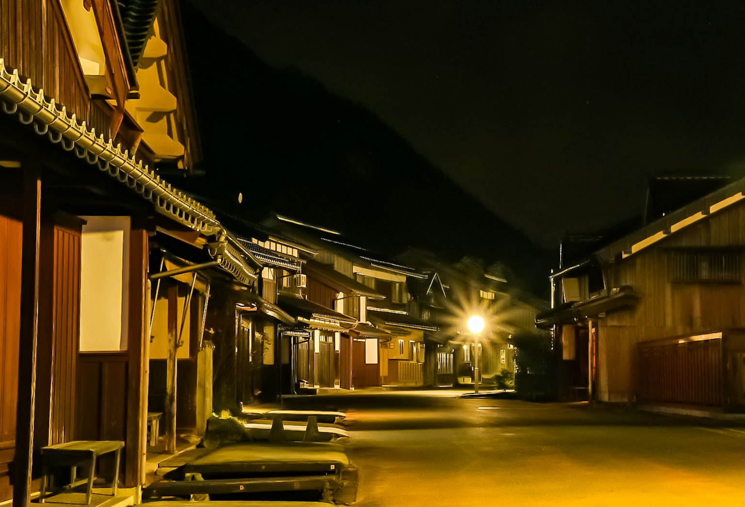 Quiet street scene at night with traditional Japanese buildings
