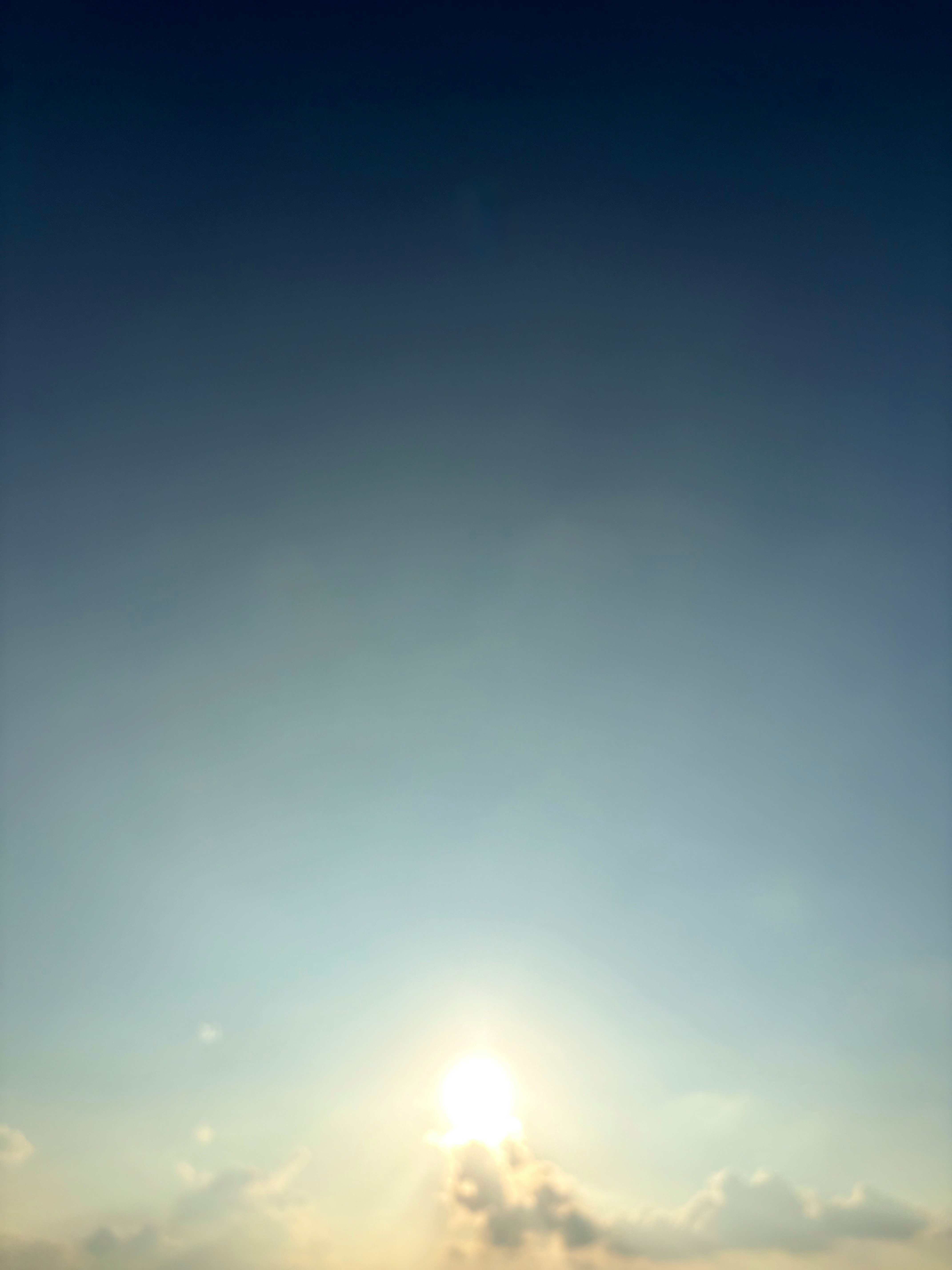 太陽の光が差し込む雲のある青い空