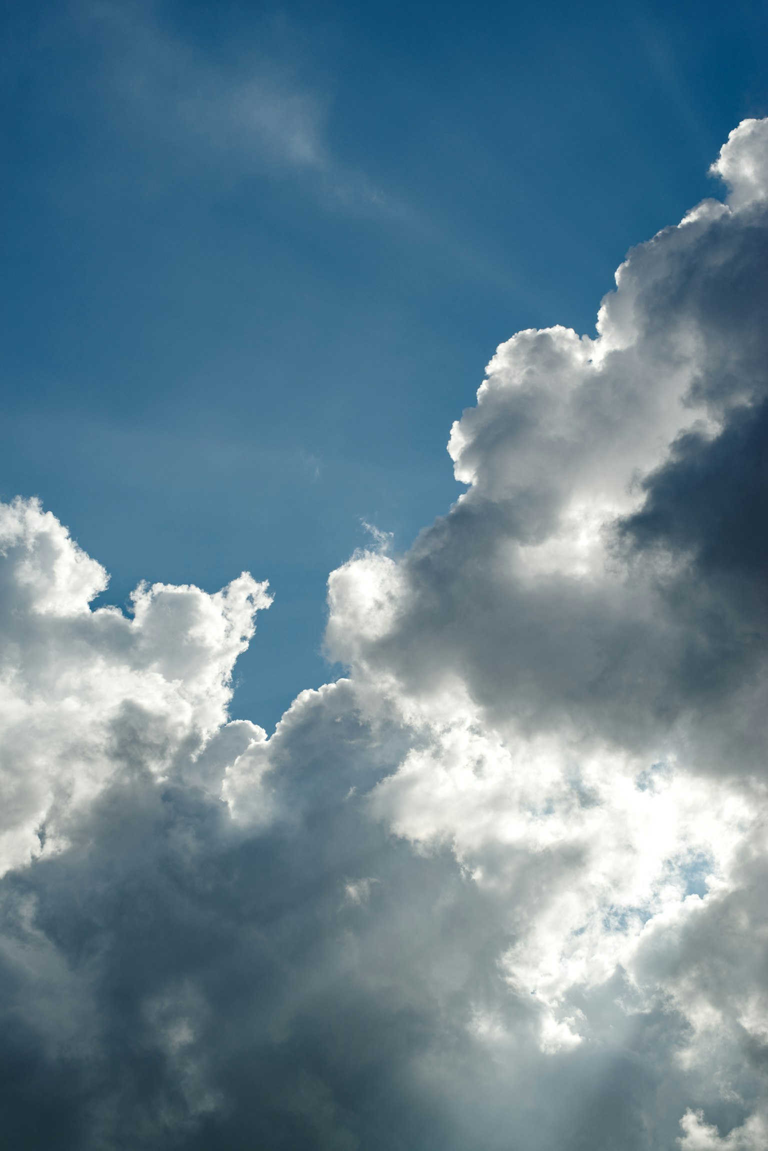 Nuvole bianche illuminate dalla luce del sole contro un cielo blu
