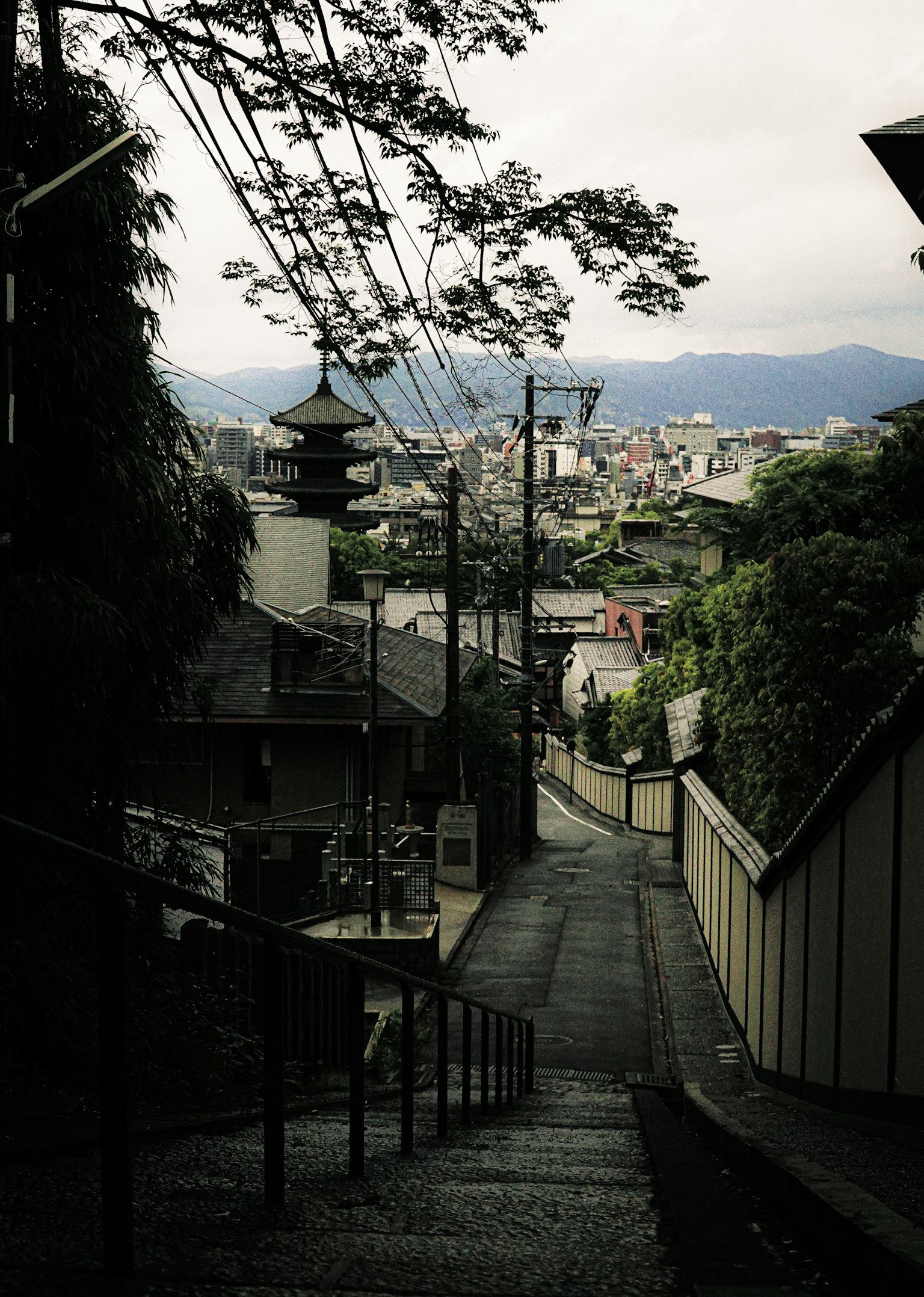 A quiet sloping path overlooking the city with old buildings