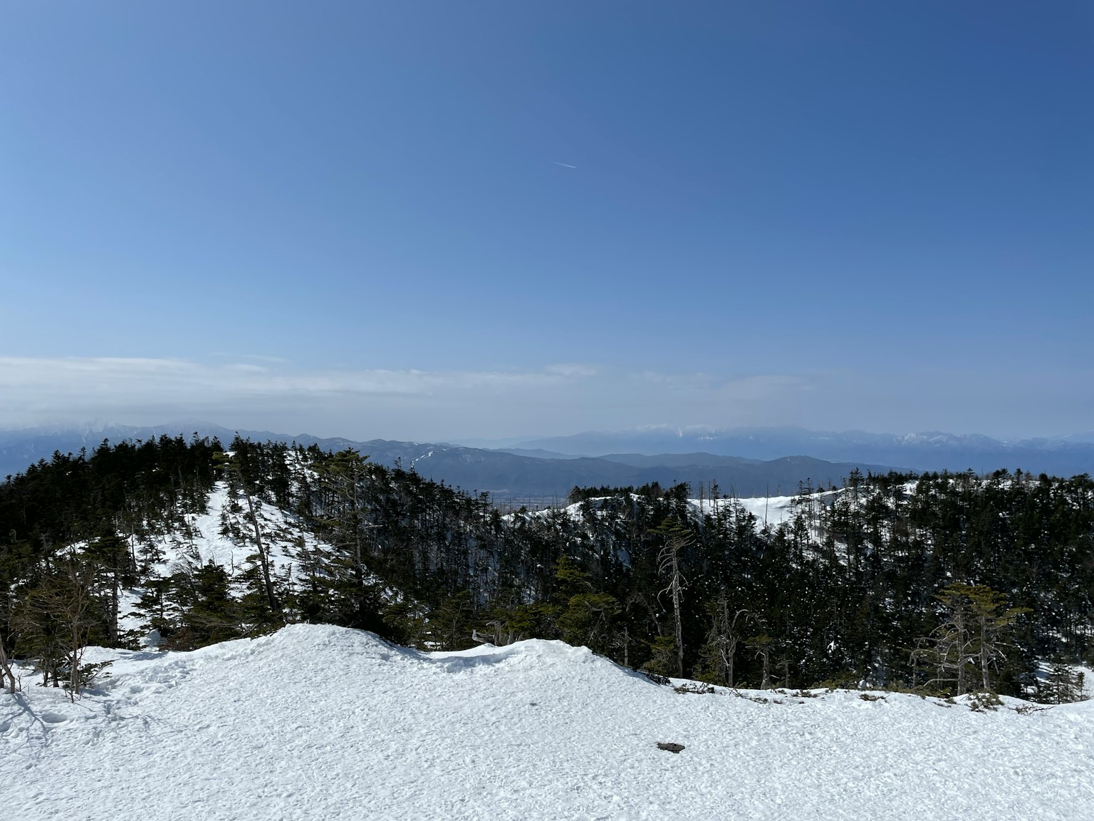 Snow-covered mountain landscape with clear blue sky
