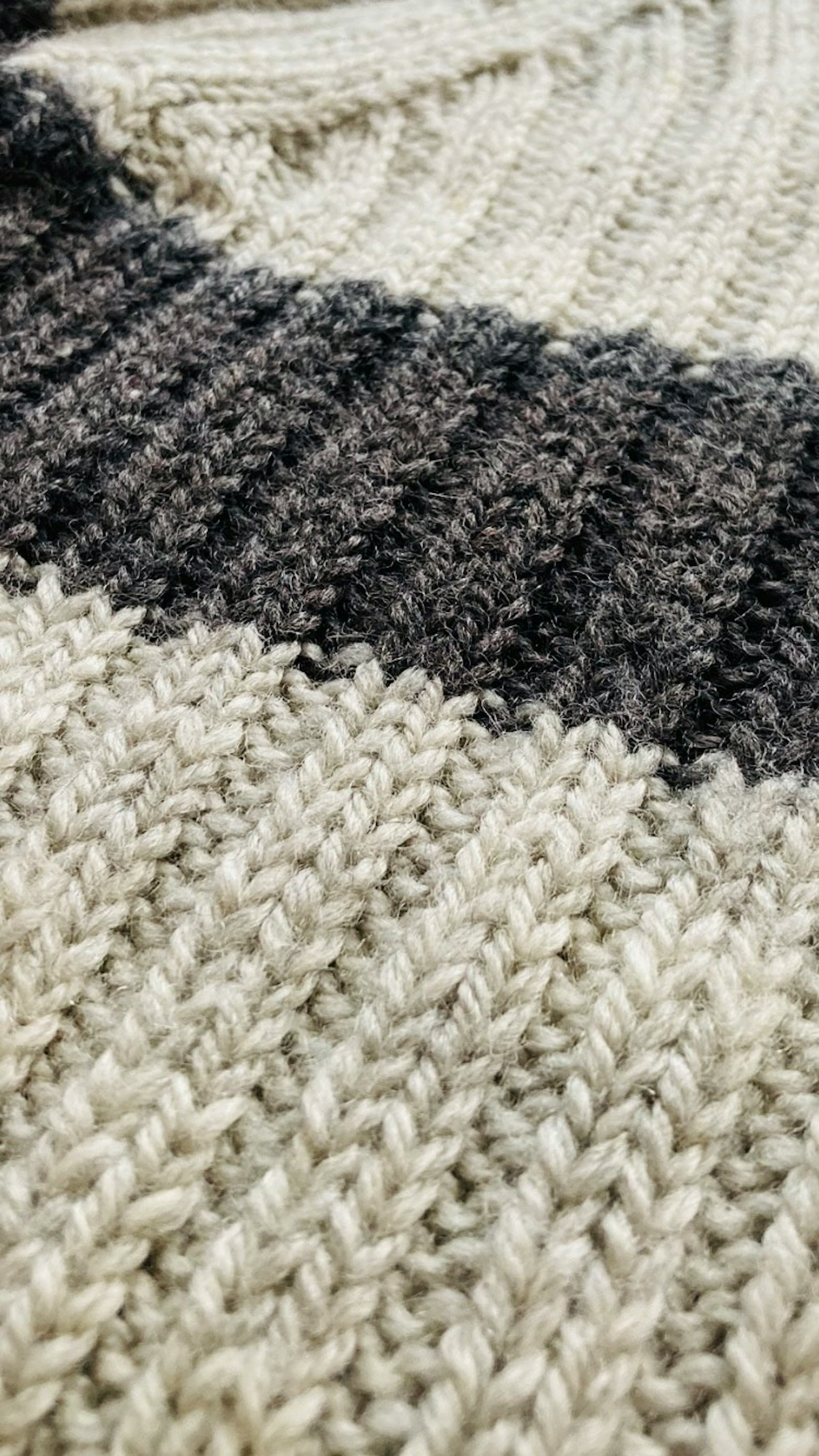 Close-up dari kain rajut dengan pola garis hitam dan putih