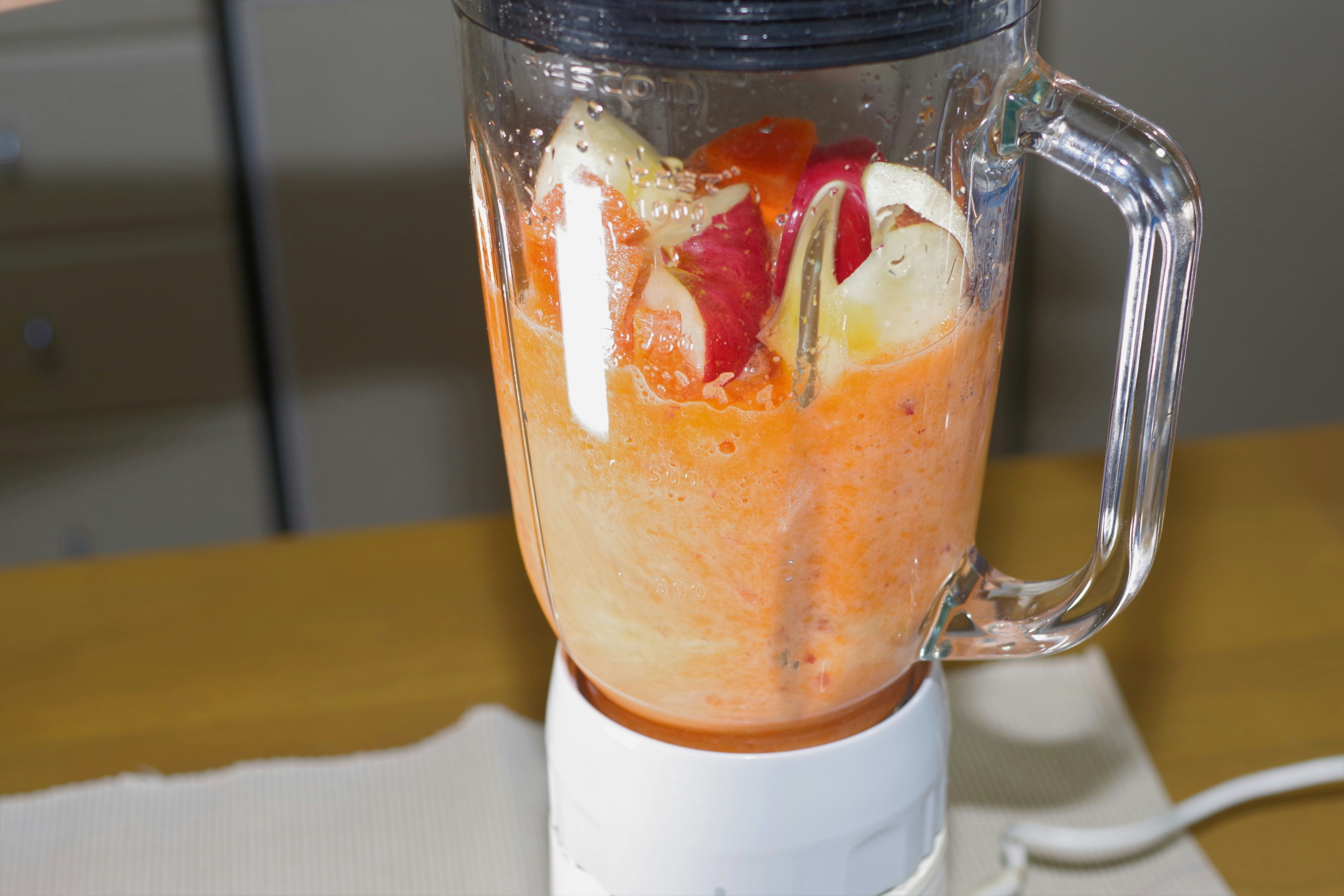 Vegetable and apple smoothie being blended in a mixer