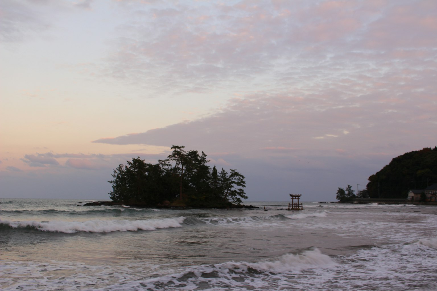 Seascape with an island during twilight softly crashing waves