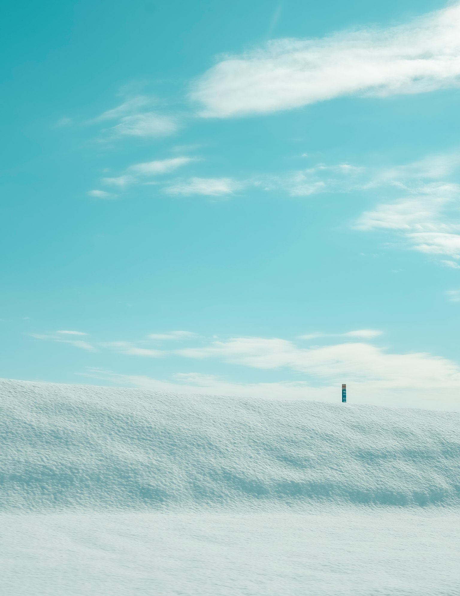 Snow-covered landscape with a bright blue sky