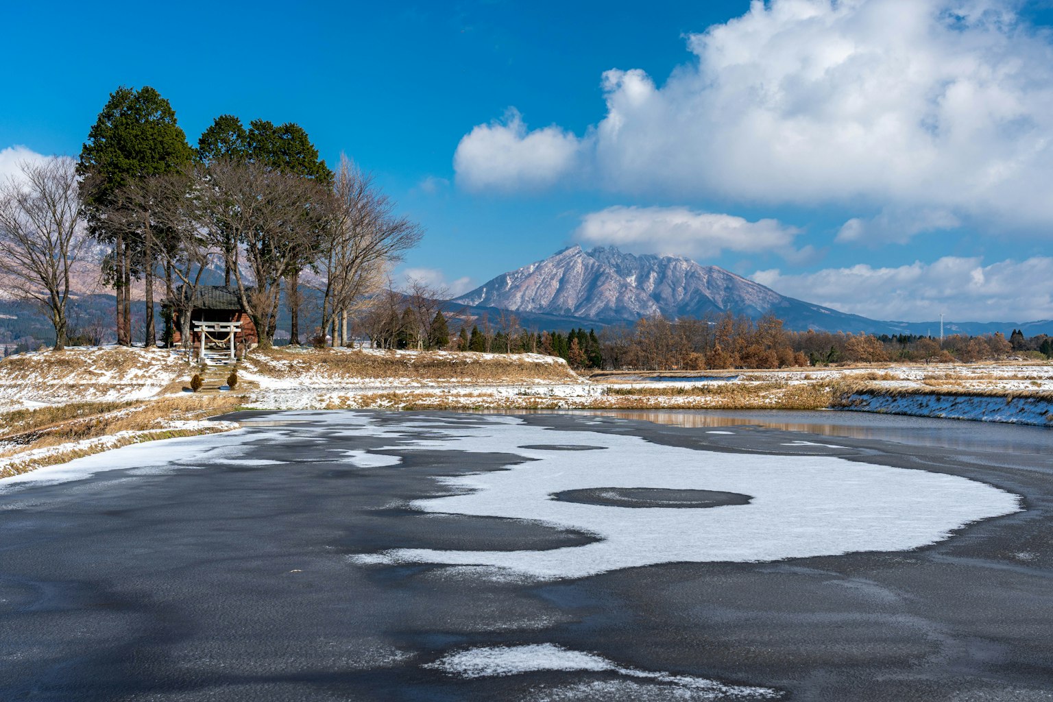 Winter landscape with snow-covered ground and clear blue sky
