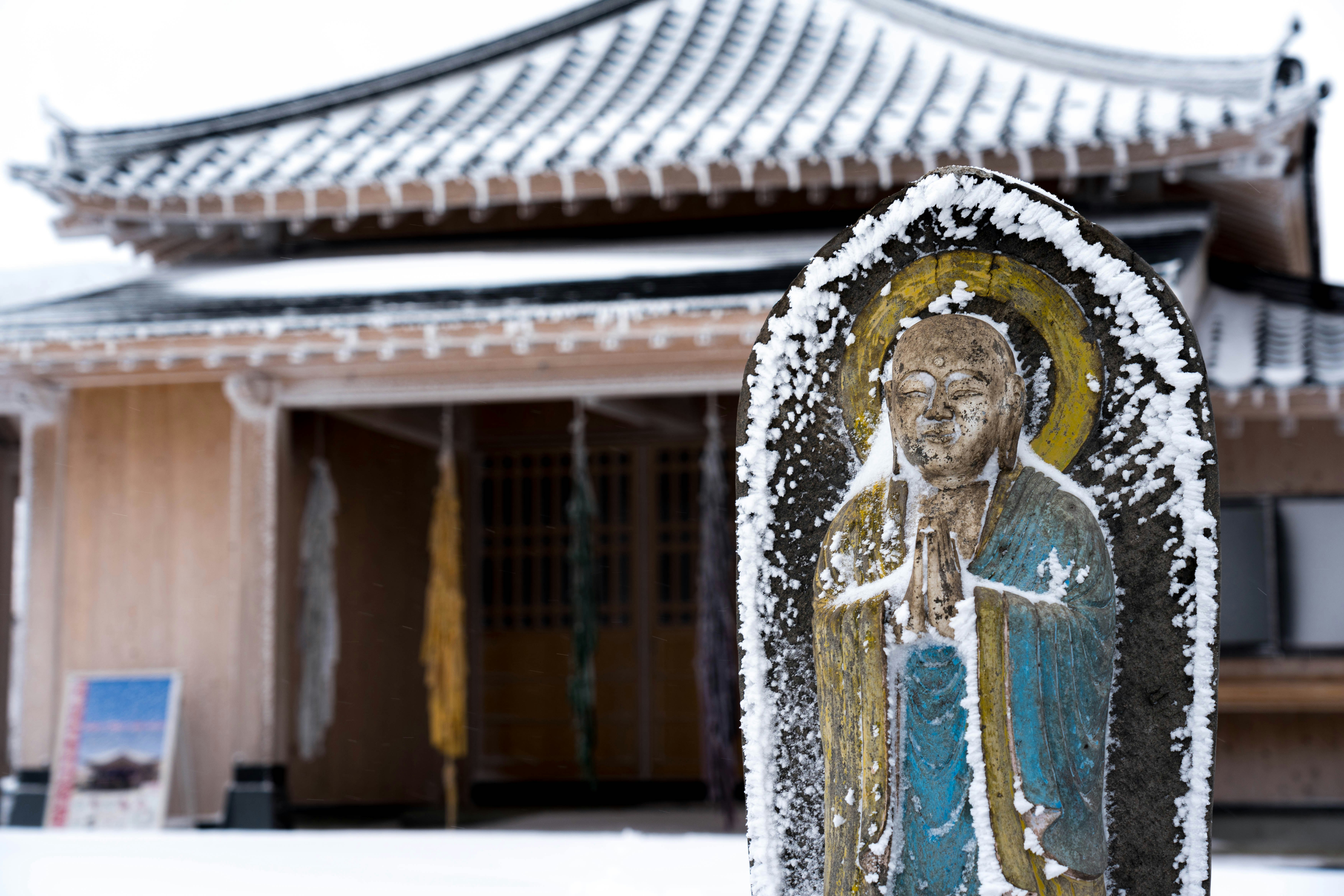 prayer statue placed in front of a temple