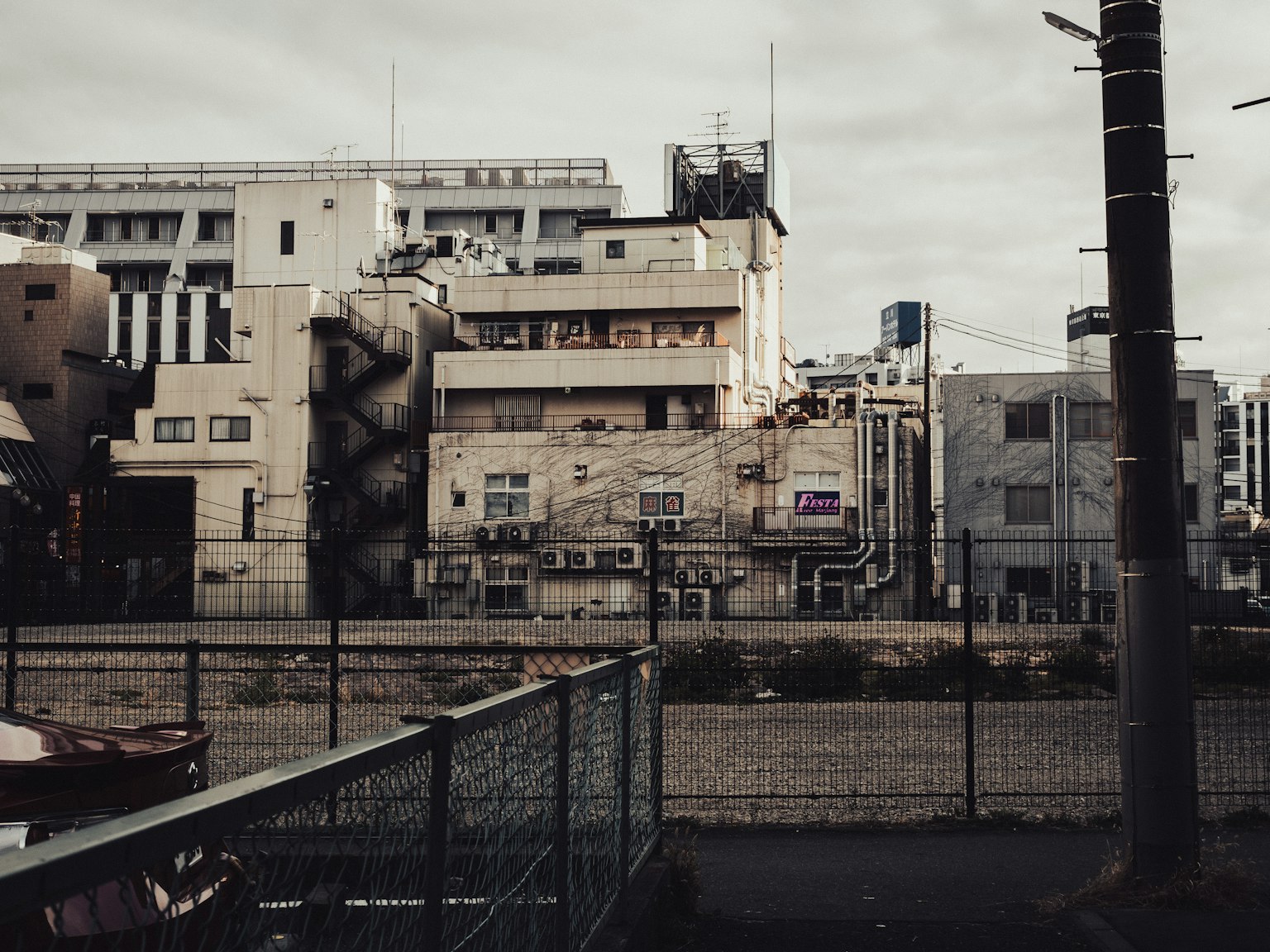 Urban landscape featuring old buildings and railway tracks in a muted setting