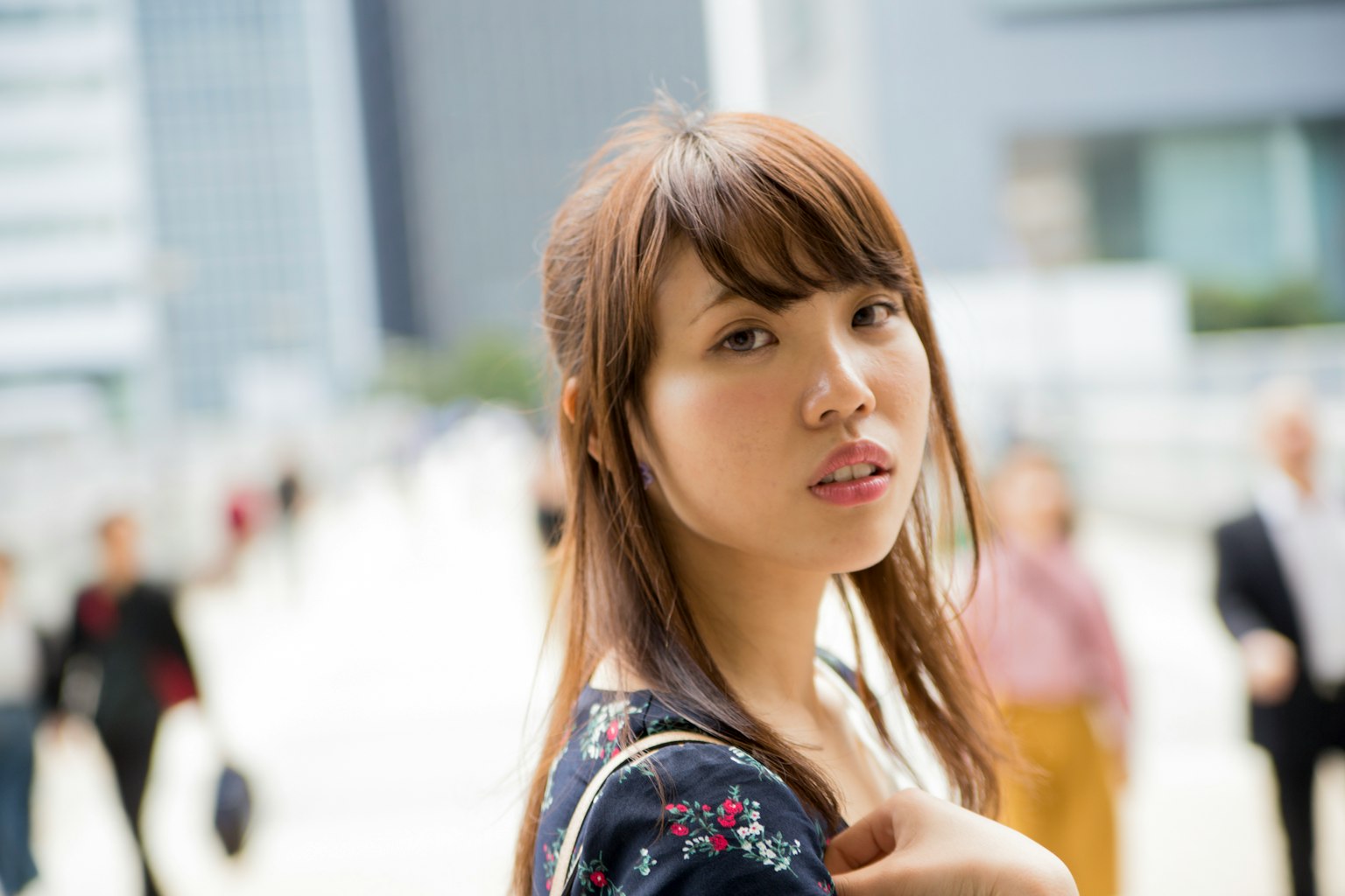 Retrato de una mujer con fondo urbano Cabello largo usando un vestido floral