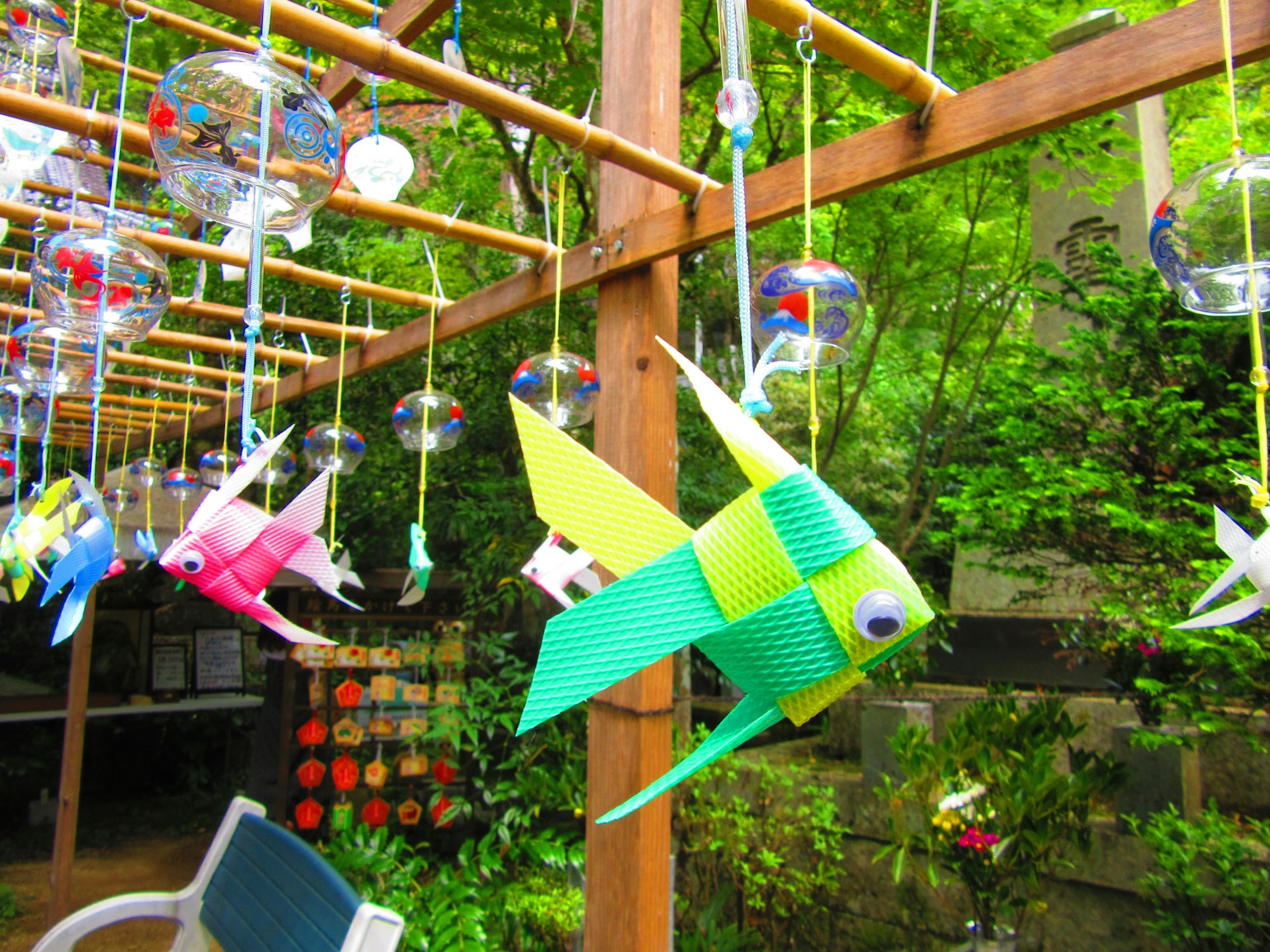 Bunte Fischdekorationen, die in einem Garten hängen
