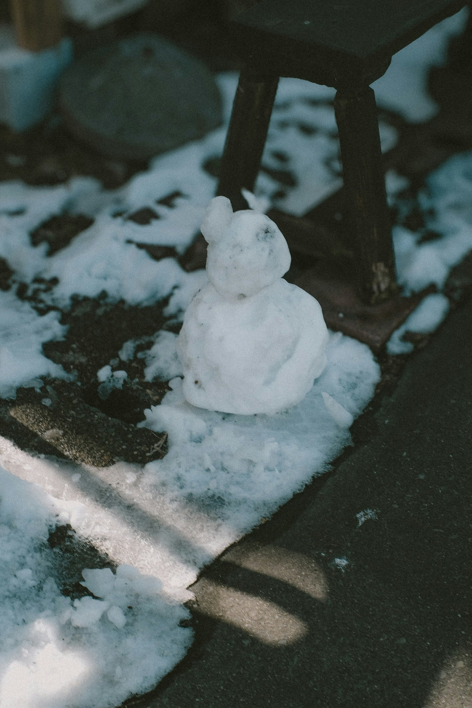 Snow rabbit sculpture on the ground with surrounding snow