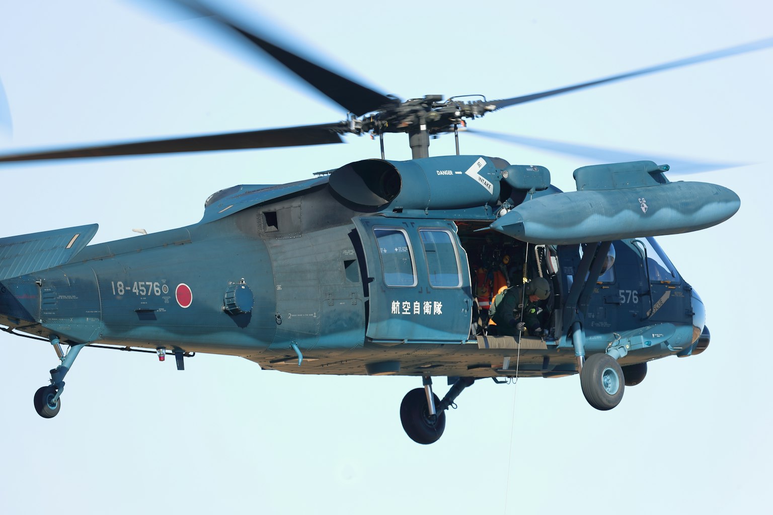 Blue Japanese helicopter flying in the air