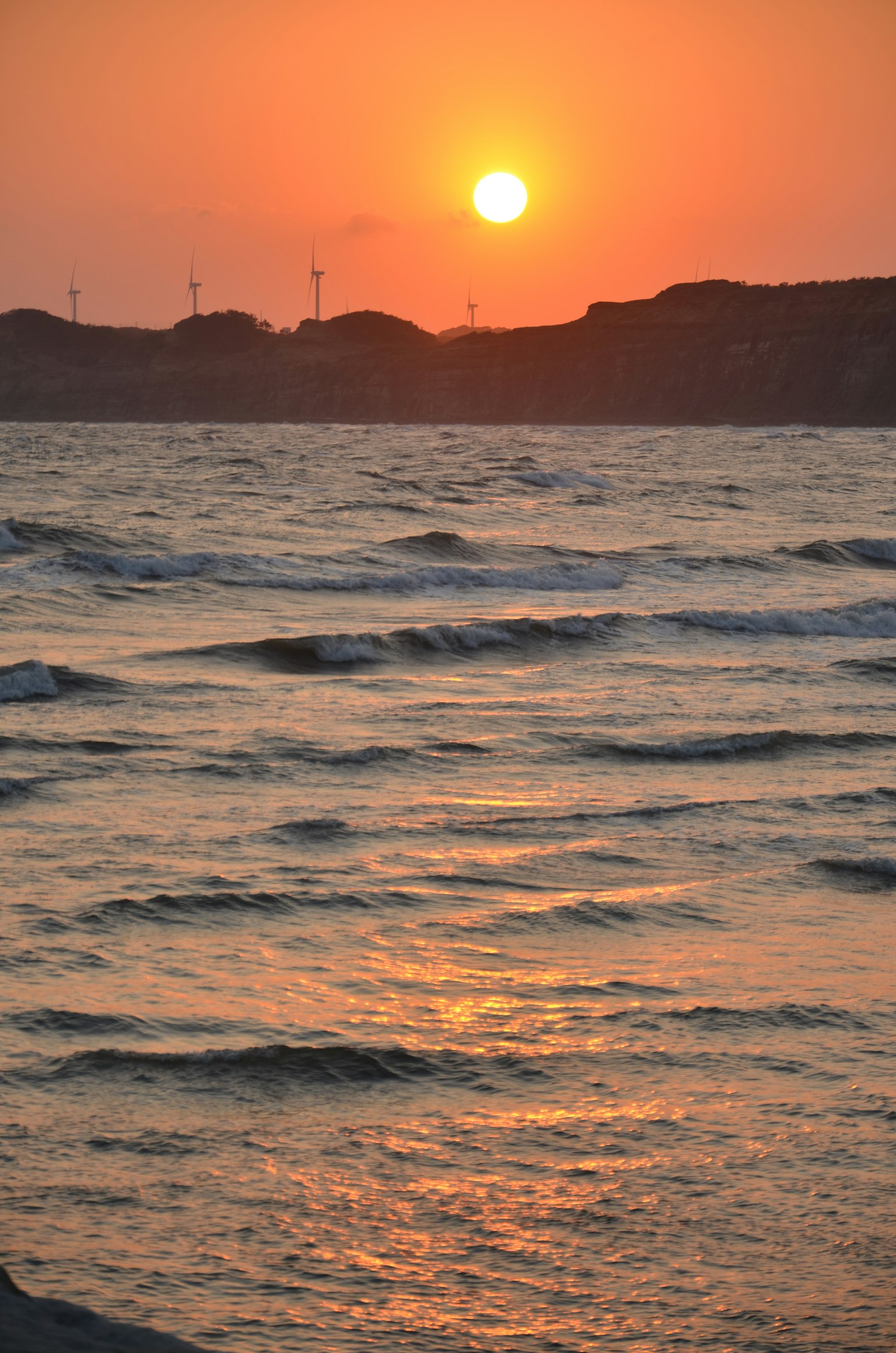 Beautiful sunset over the ocean with waves