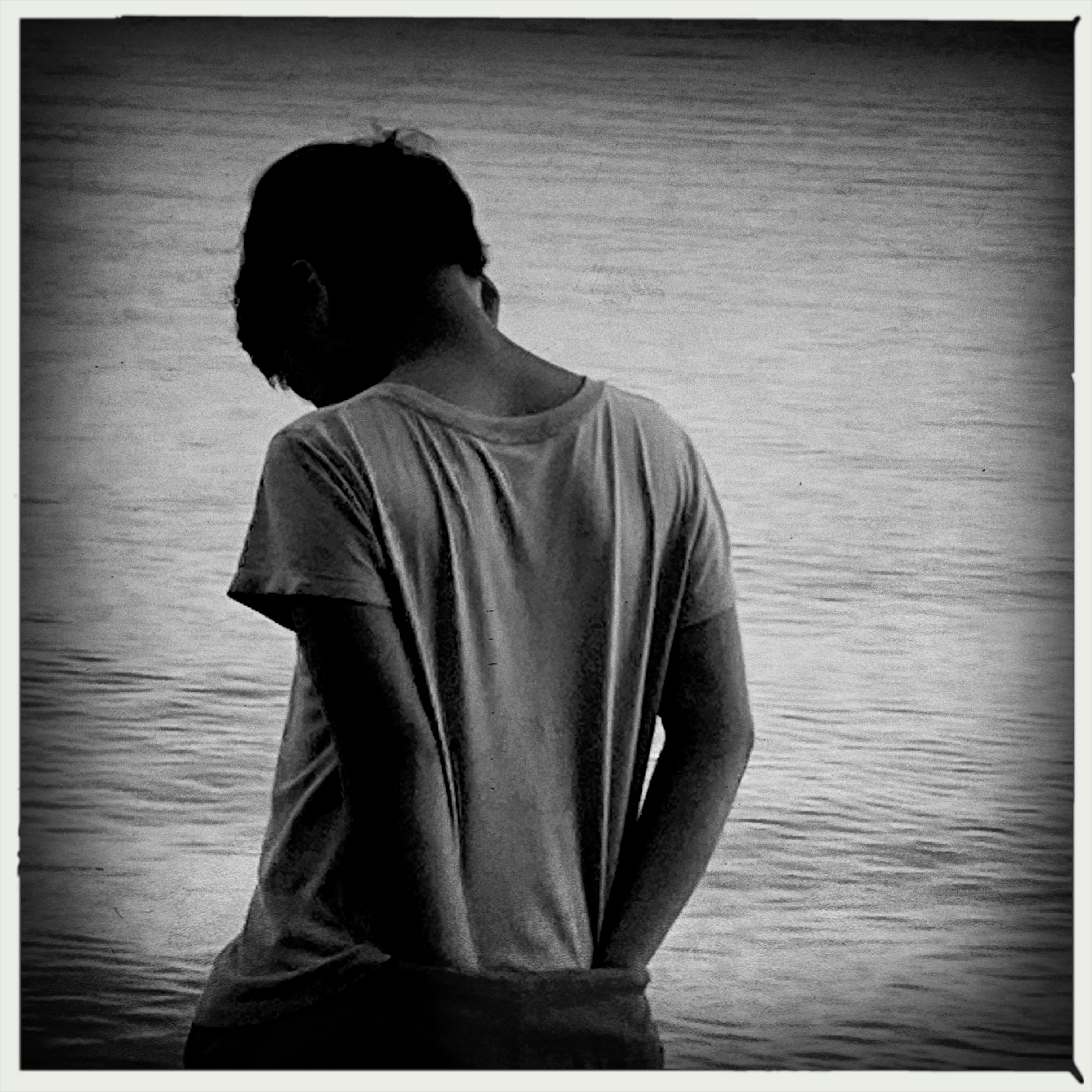 silhouette of a person standing by the sea
