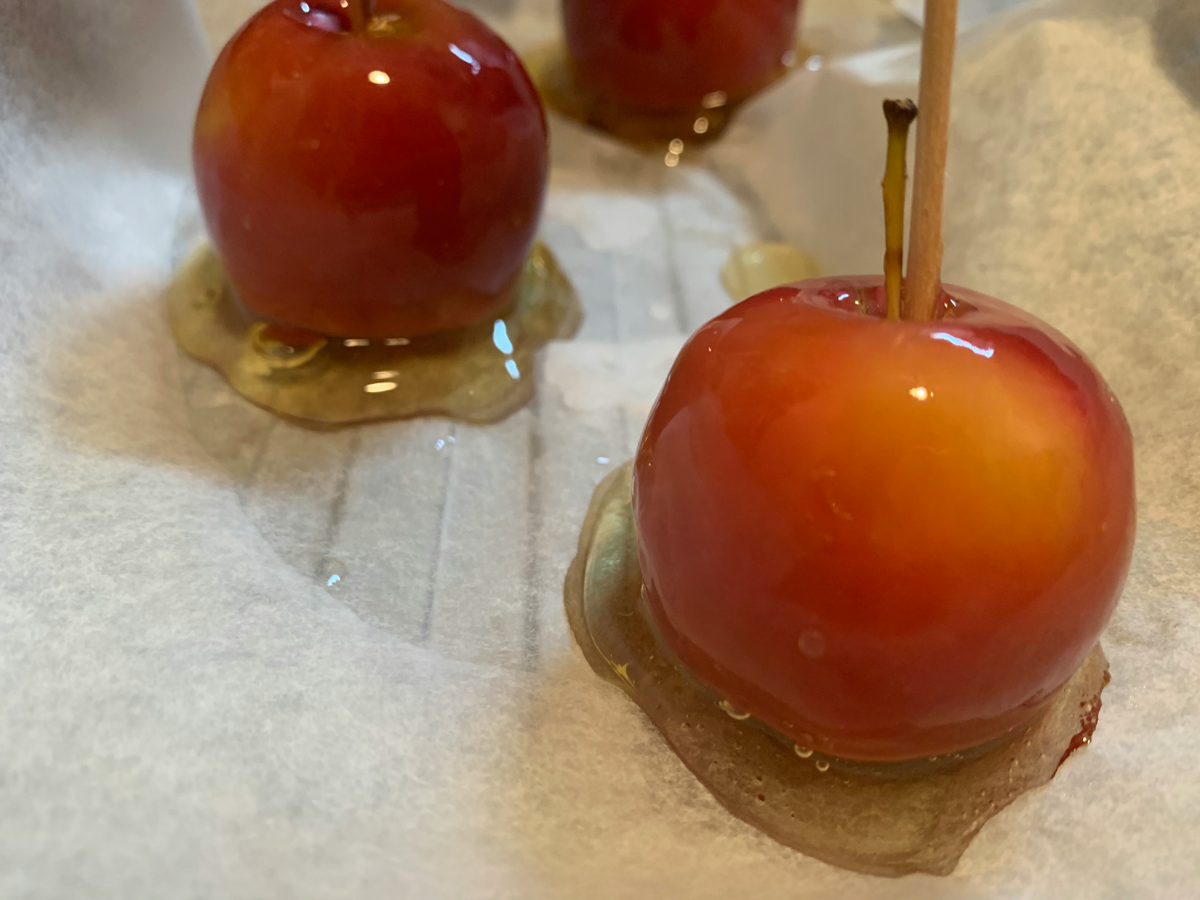 Close-up of glossy caramel apples on display