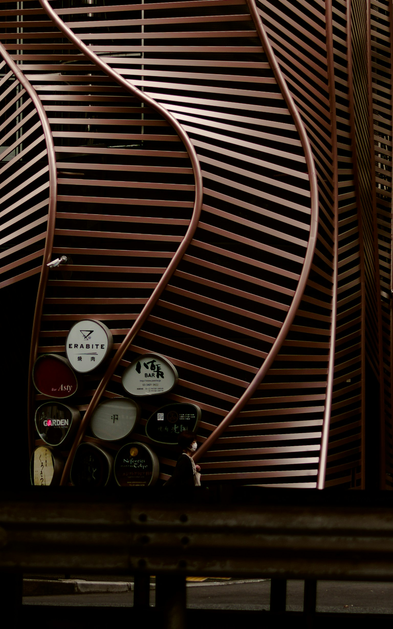 Modern architectural detail featuring curved wooden slats and gauges