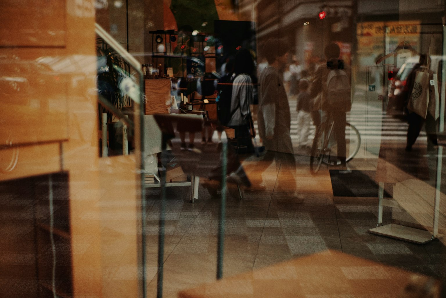 A street scene reflected in a window with people walking by
