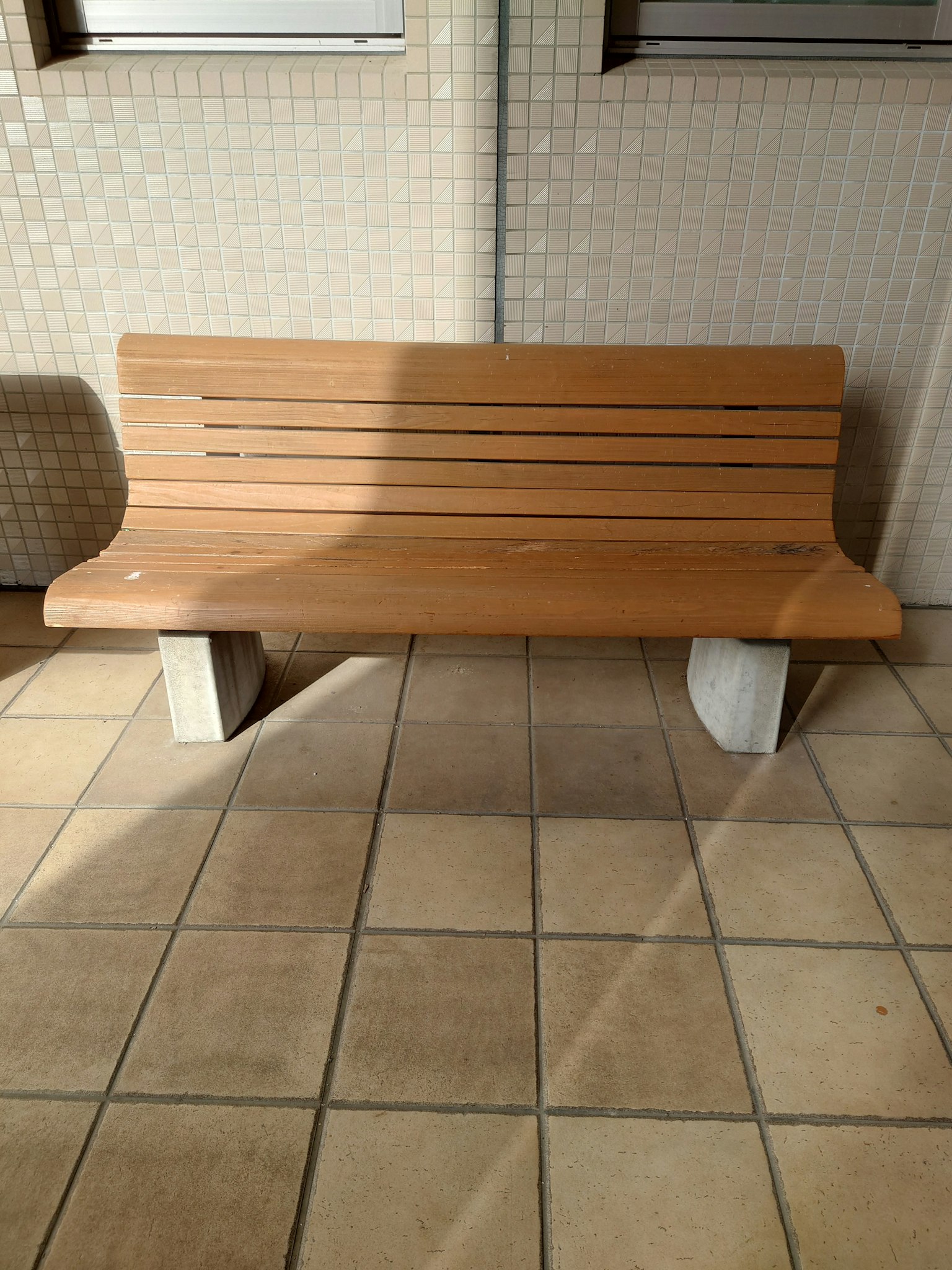 Wooden bench on tiled floor with simple design