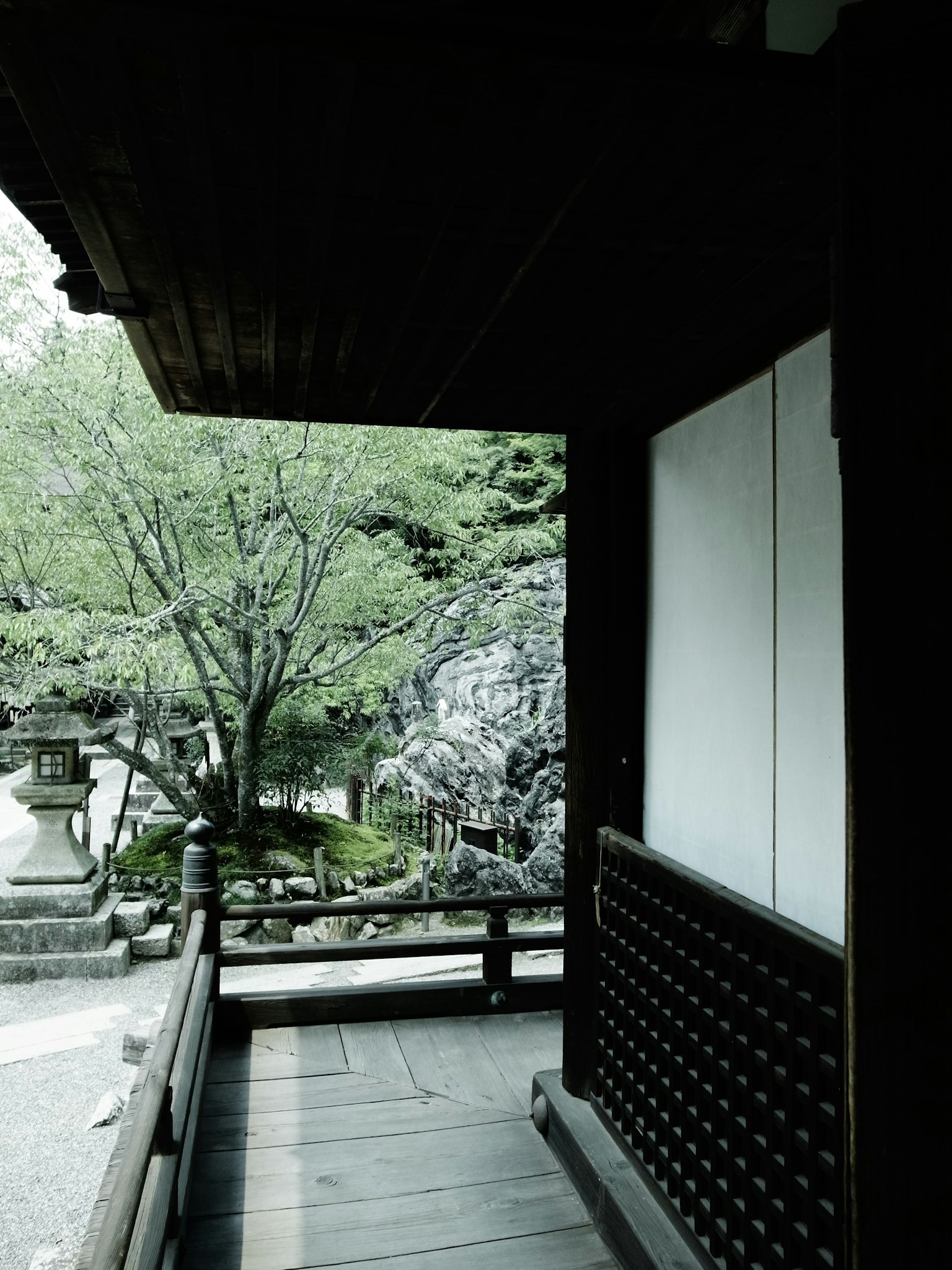 Porche de madera con vista a un jardín japonés sereno y verde