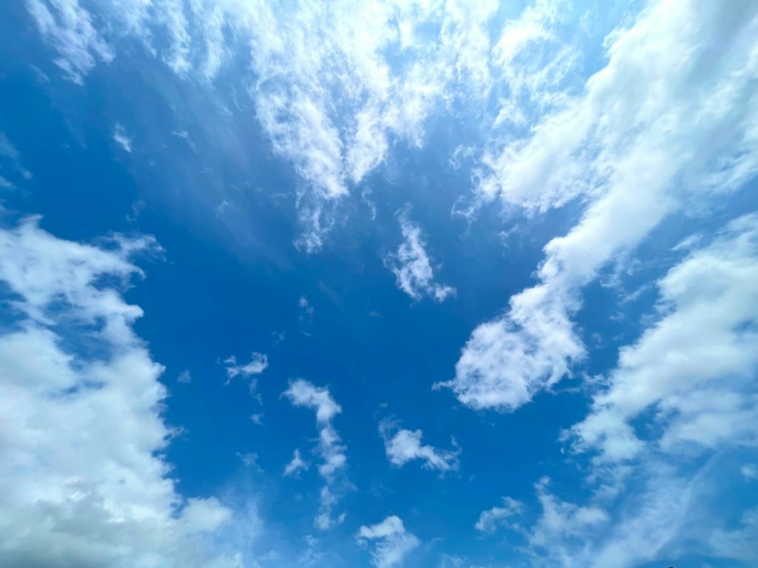 Vibrant blue sky with fluffy white clouds
