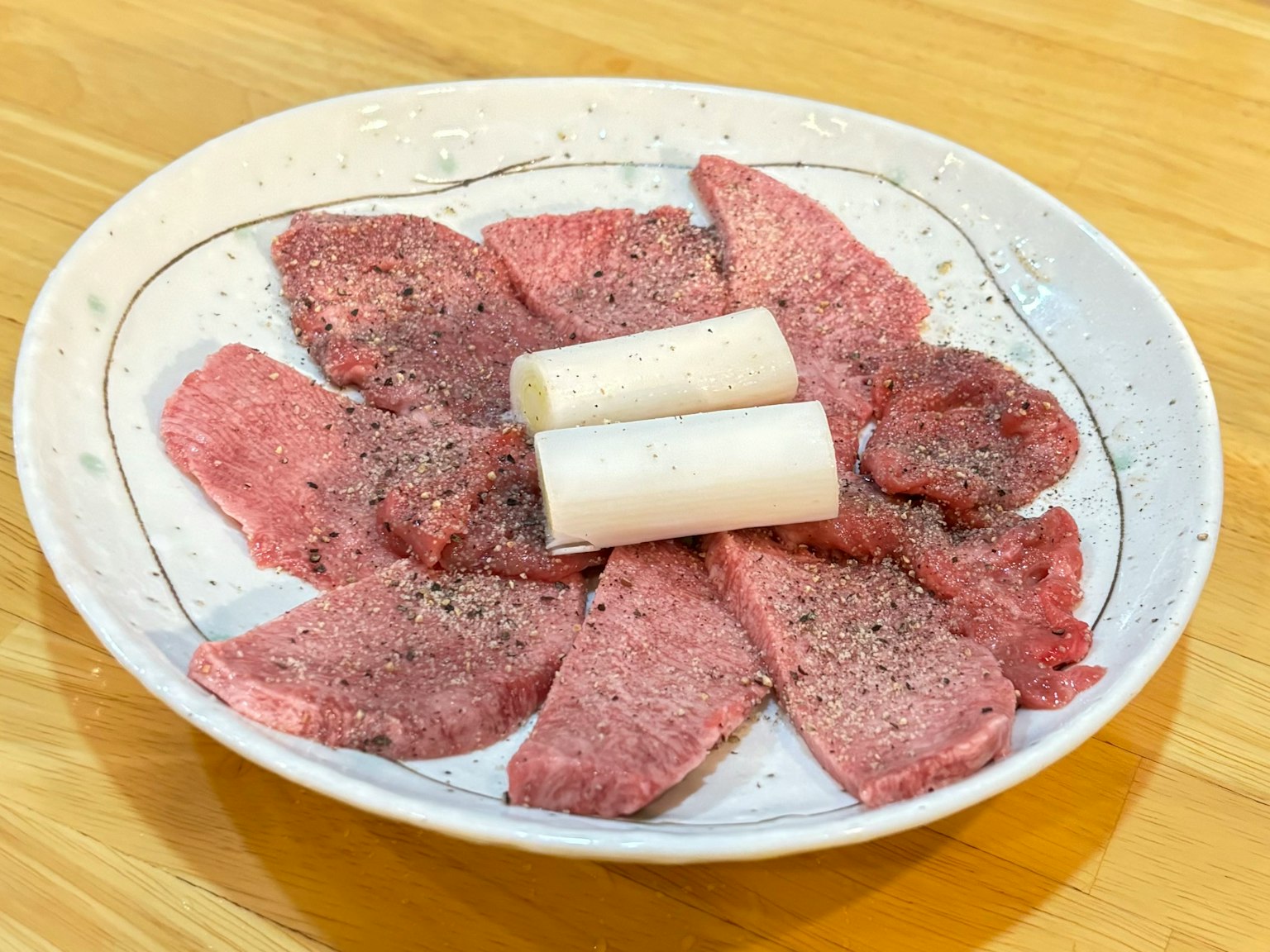 Sliced beef and radish arranged on a plate