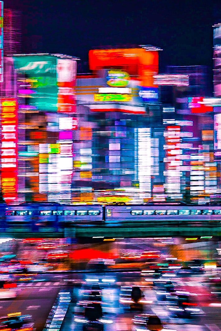 Neon-lit night city street with light trails
