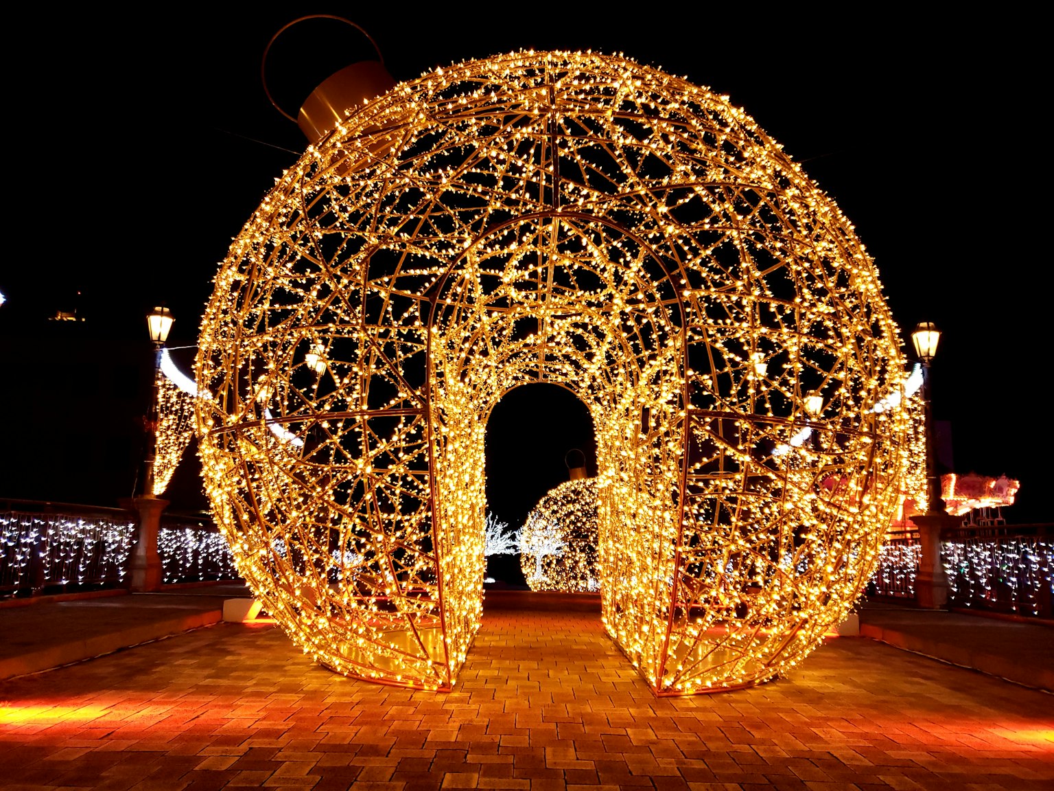 Illuminated arch structure made of lights at night