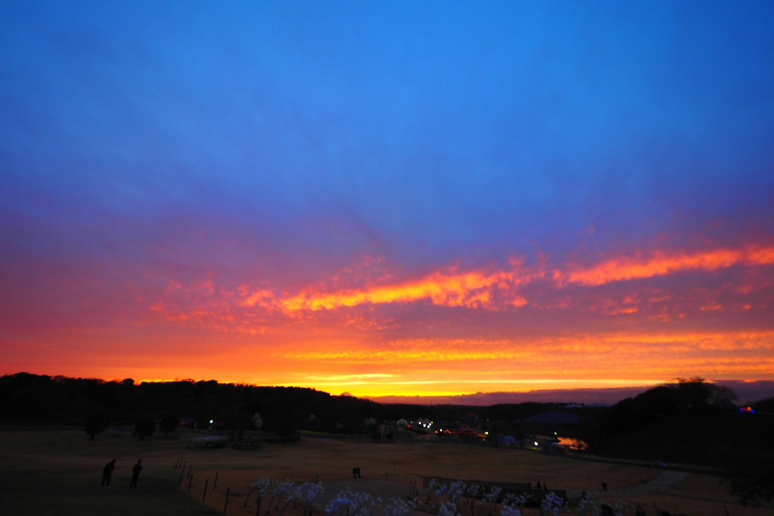 Vibrant sunset with colorful sky and silhouetted hills