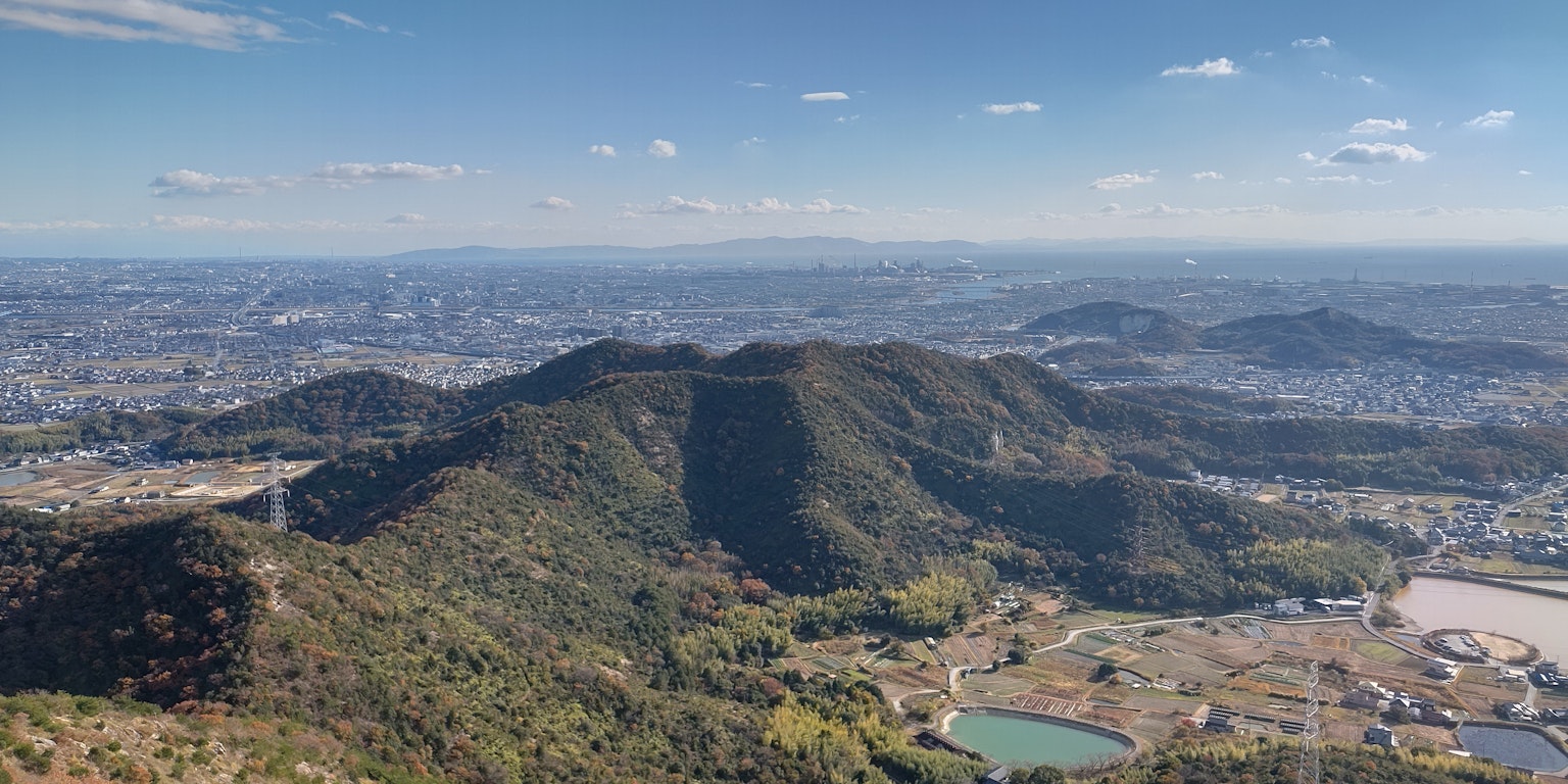 Aerial view of mountains and cityscape with lush greenery