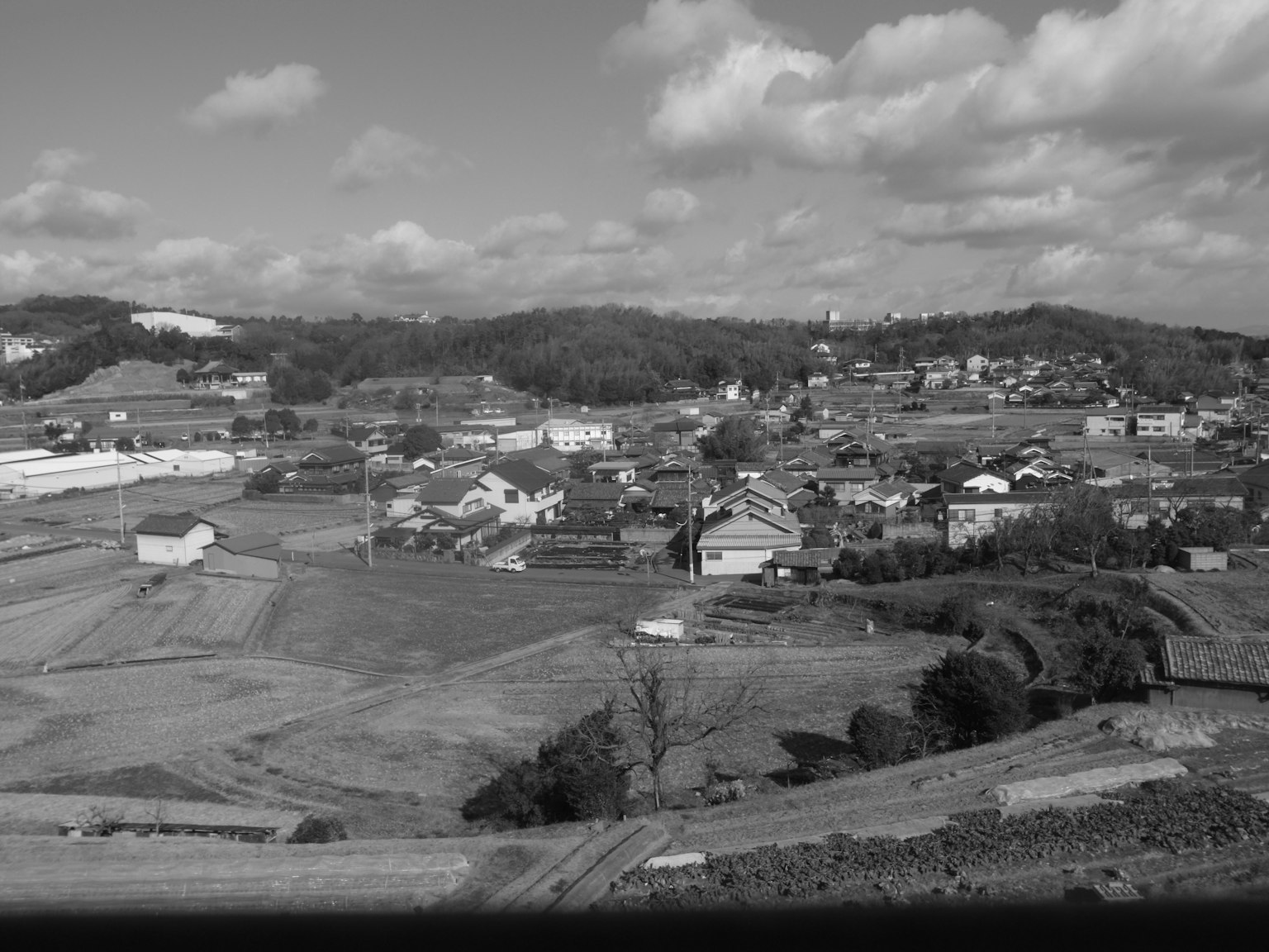 Black and white landscape photo of a village and farmland panorama
