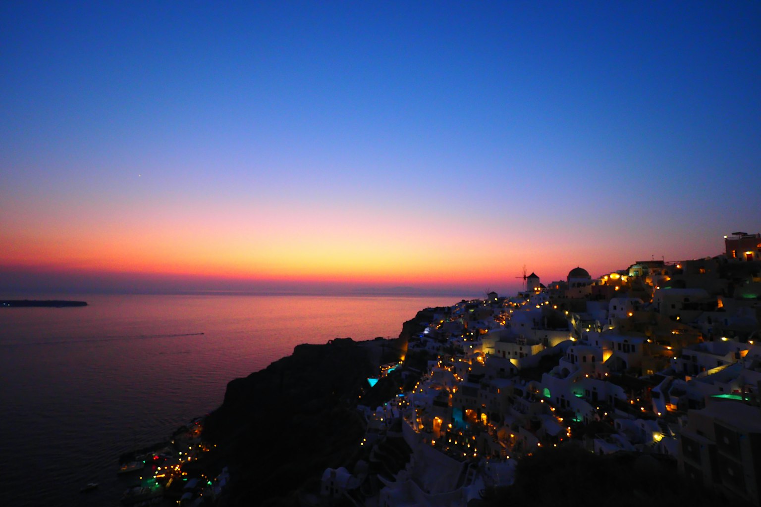 Bellissima vista costiera al tramonto con case illuminate