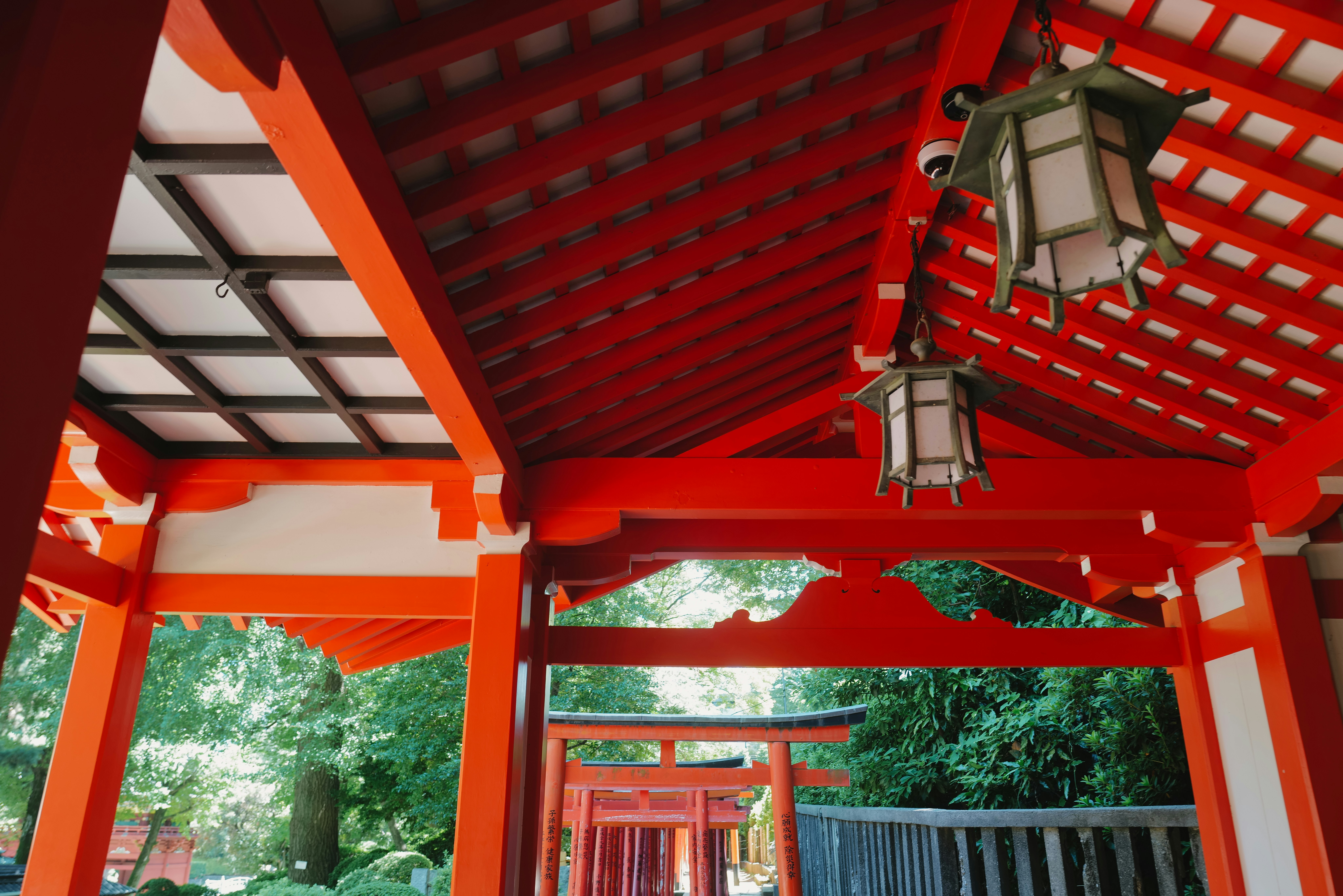 Vermilion torii gate and shrine roof at a walkway