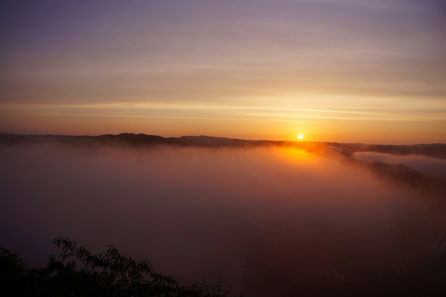 Beautiful sunrise over mountains shrouded in fog