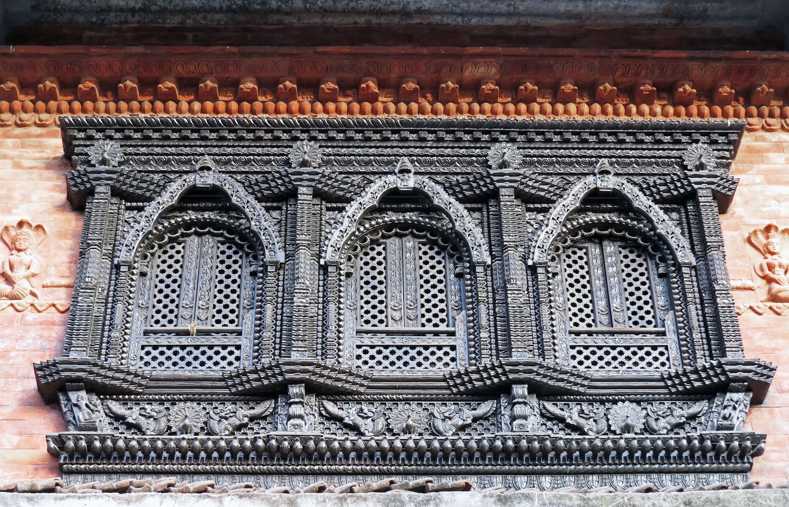 Intricate wooden window frame showcasing traditional Nepali architecture